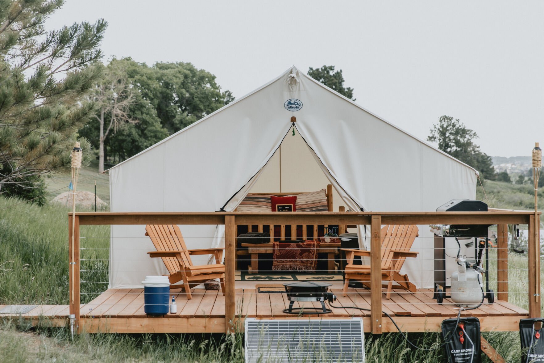 When Monument couple Chris and Wendy Jeub redid their bedroom in 2019 and slept on a platform Chris built in their backyard, they fell in love with glamping, a combination of the words glamorous and camping, and outdoor hospitality. Now in their fifth season, Monument Glamping I and Monument Glamping II offer safari tents on platforms, tiny houses, container units, bell tents and treehouses. Photo by Freedom Real Estate Photography