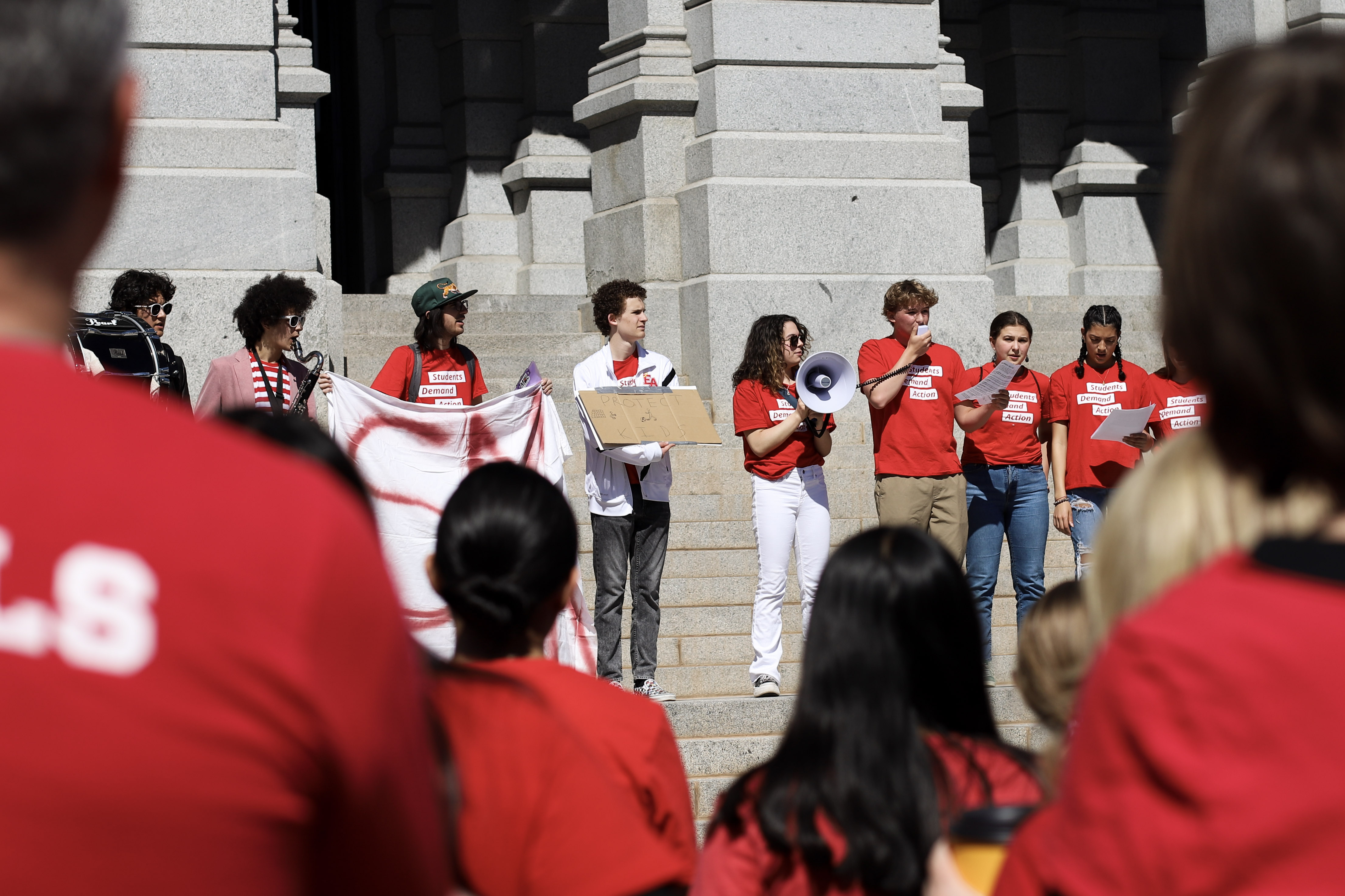 Organizers with Students Demand Action stand on the steps of the capitol, demanding stricter gun laws at a rally Saturday morning. (Kyla Pearce)