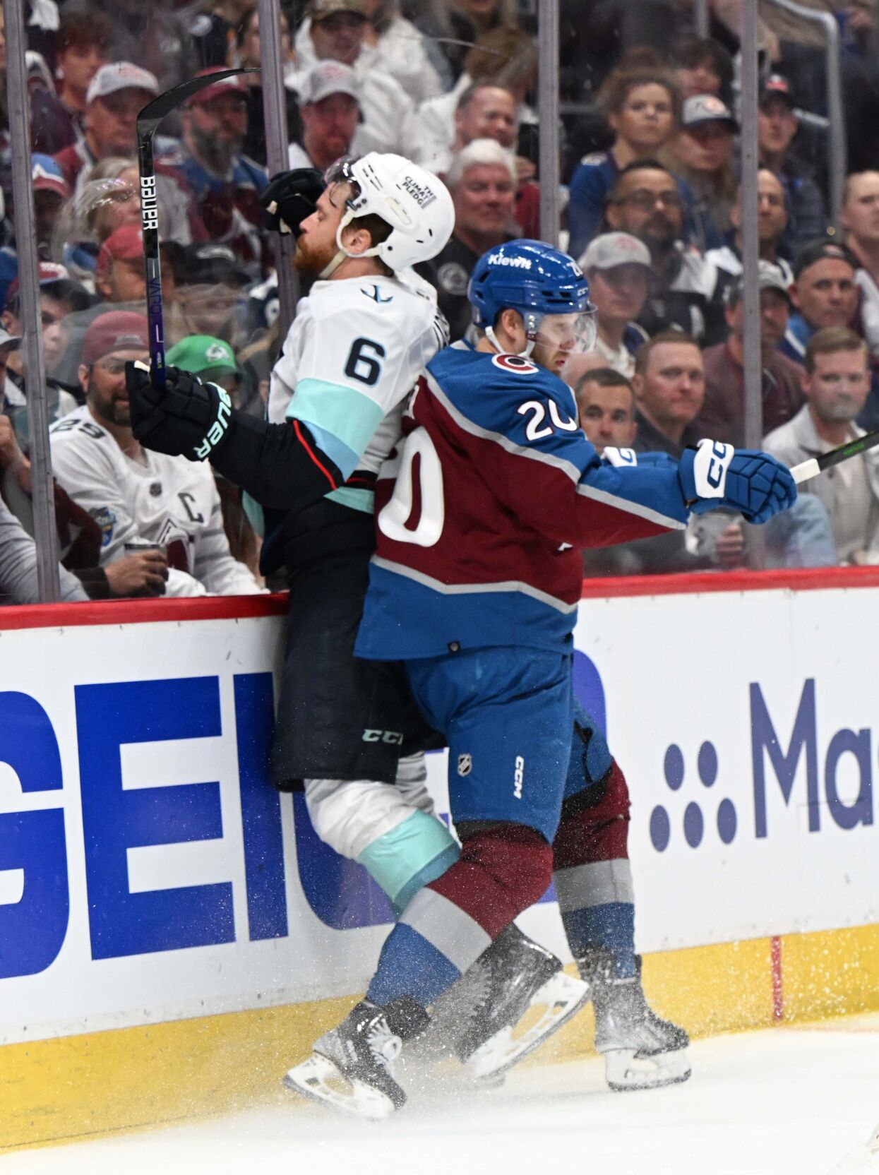 Colorado Avalanche center Lars Eller (20) checks Seattle Kraken defenseman Adam Larsson (6) into the boards during the first period of Game 7 of the first round of the Stanley Cup Playoffs Sunday, April 30, 2023, at Ball Arena in Denver. (The Gazette, Christian Murdock) (Christian Murdock/The Gazette)