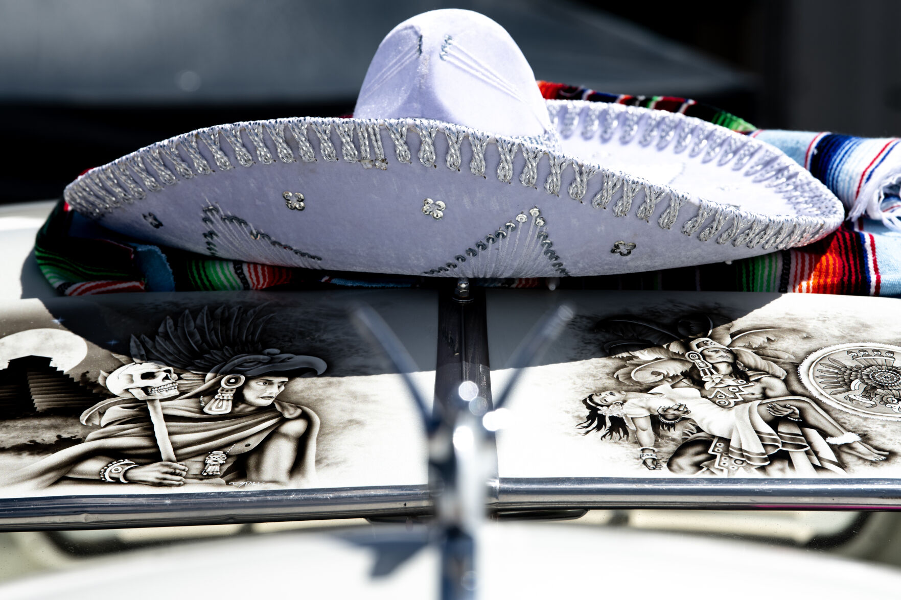 A sombrero sits above a detailed painting on the hood of a car at the 39th annual Cinco De Mayo Festival and Car show at Memorial Park on Saturday. The event is a vibrant tradition in the area, with the goal of sharing Mexican and Hispanic culture and activities with the surrounding community. (Parker Seibold)