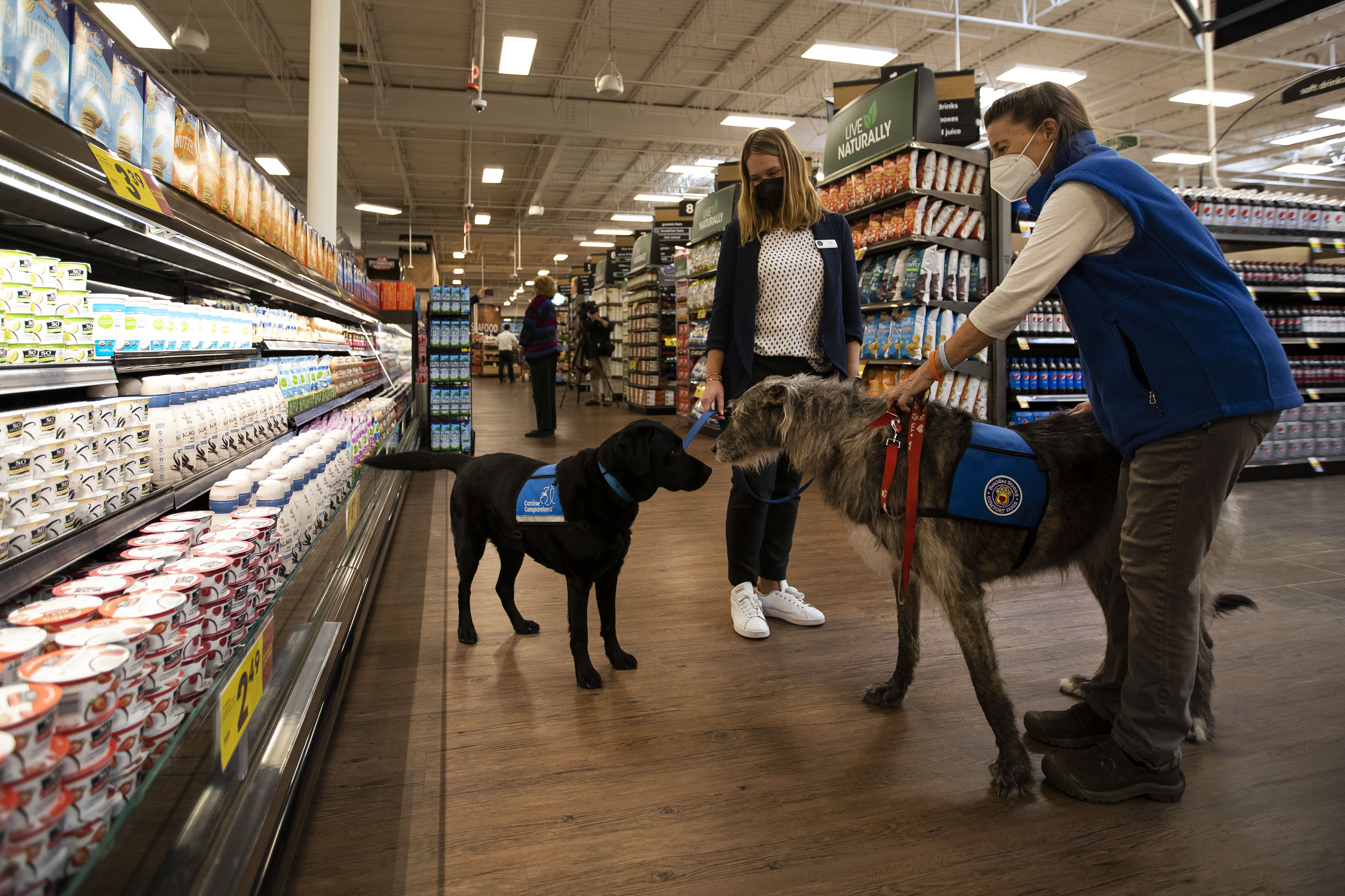 FILE PHOTO: Director of the Center for Prevention and Restorative Justice in Colorado’s 20th Judicial District, Elaina Shively, and the DA’s office’s comfort dog, Buck, left, meet Nancy Malchow and therapy dog Willow while touring the King Soopers grocery store on Table Mesa Drive that was the scene of a mass shooting last year, as seen on Tuesday, Feb. 8, 2022, in Boulder, Colo. (Timothy Hurst/The Gazette) (Timothy Hurst/The Denver Gazette)