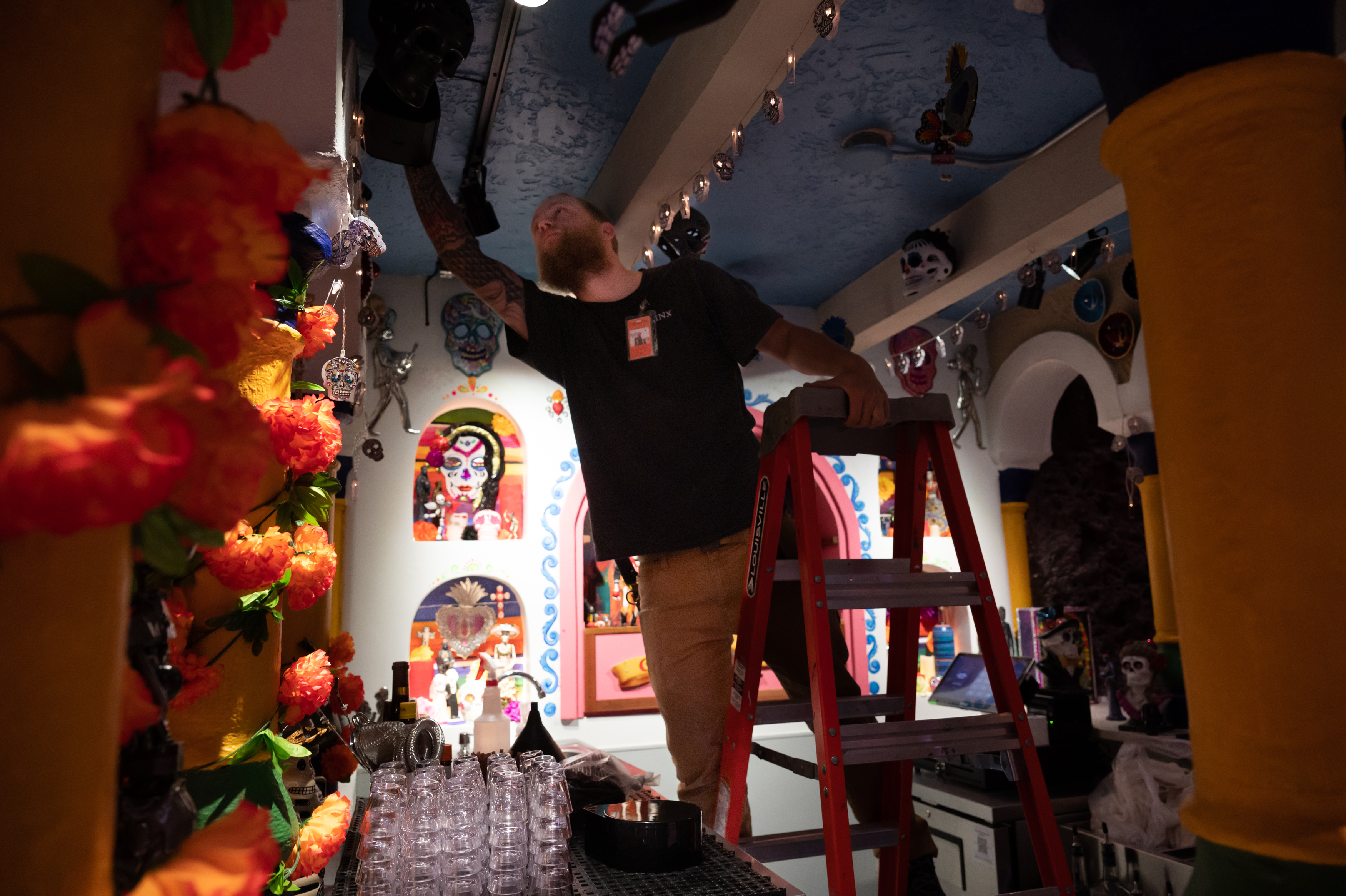 A worker is seen putting finishing touches on the Casa Bonita Dia de los Muertos Bar in this handout photo, provided on May 26, 2023. (Casa Bonita)