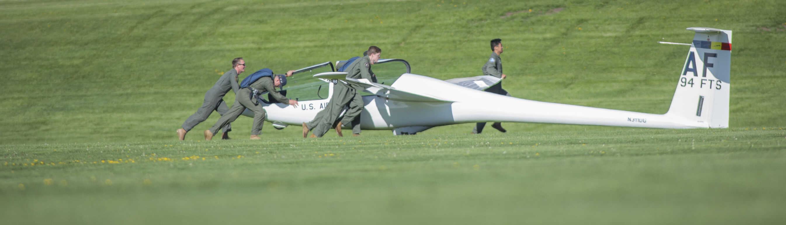 Cadets work together to push a glider off of Stillman Field at the U.S. Air Force Academy Class of 2023 Graduation Parade in Colorado Springs, Co., on Wednesday, May 31, 2023. (Gabi Broekema)