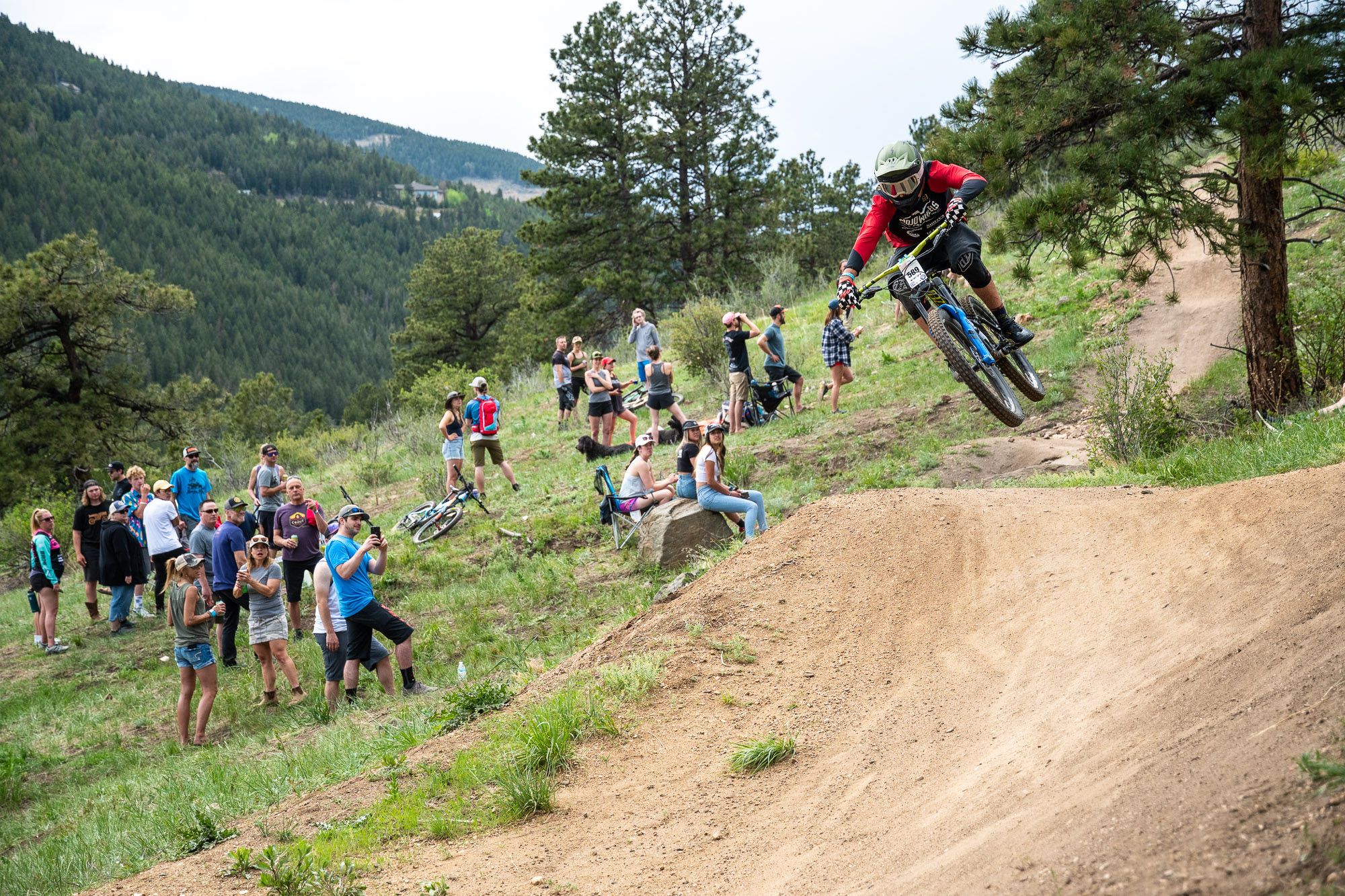 A mountain bike racer jumps his bike on The Sluice trail during a descent in the Series Session at Floyd Hill west of Genesee, Colorado. (Courtesy, Eddie Clark)