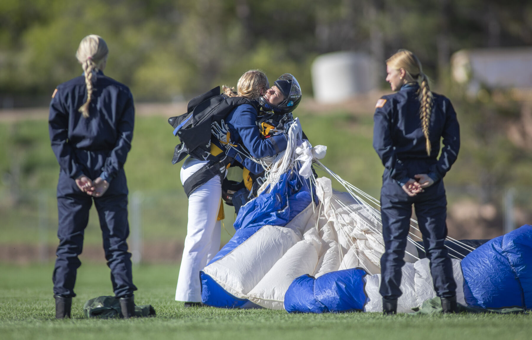 Graduating cadets Haley Brunkal and Baileigh McFall embrace after landing safely onto Stillman Field at the U.S. Air Force Academy Class of 2023 Graduation Parade in Colorado Springs, Co., on Wednesday, May 31, 2023. (Gabi Broekema)