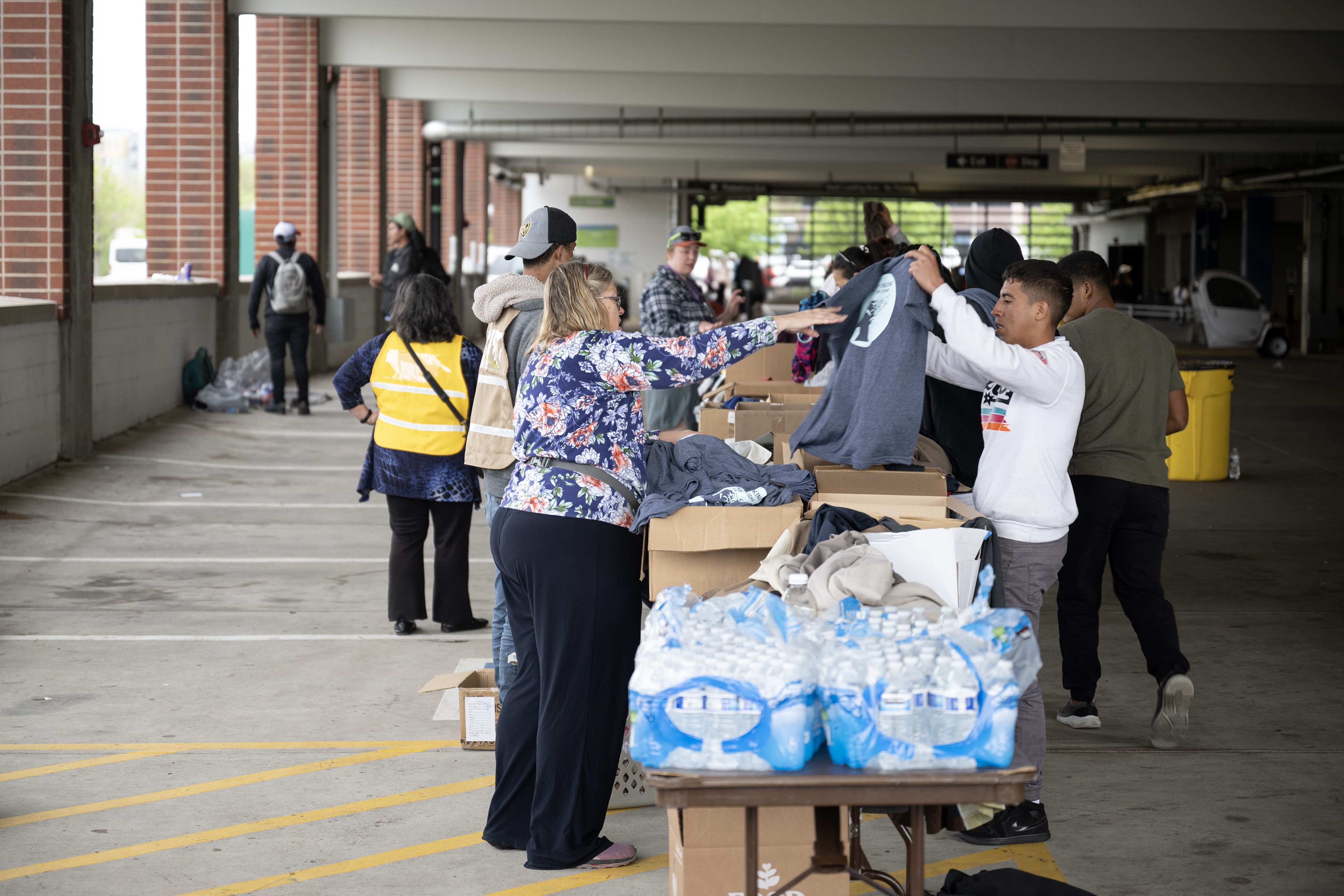 Recently arrived immigrants are provided services in a blocked-off parking garage on Wednesday, May 10, 2023, on the Auraria Campus in Denver. (Timothy Hurst/Denver Gazette) (TimHursttim.hurst@gazette.comhttps://secure.gravatar.com/avatar/aca82bd62b4ee425c598527cd6faa1b1?d=mm&r=g)