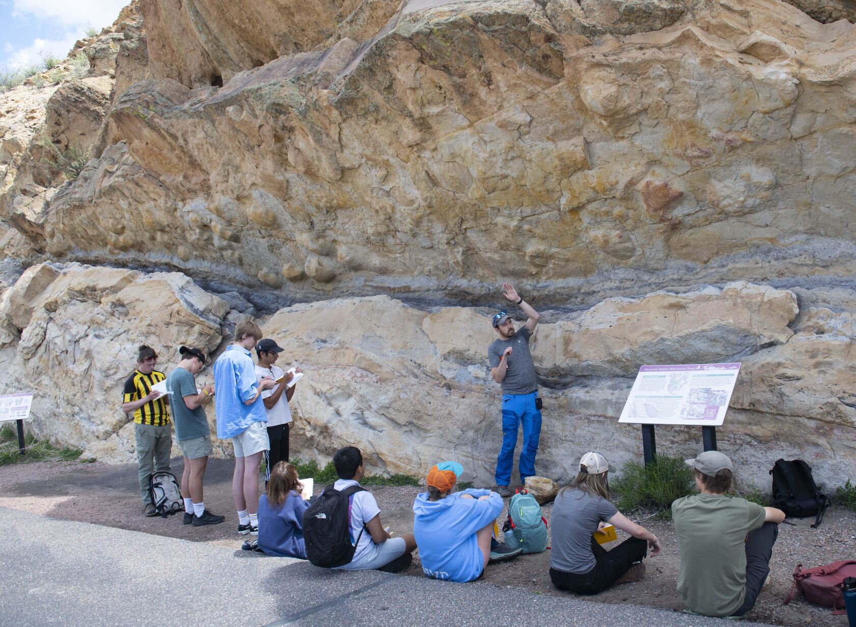 Visiting professor Tyler grambling teaches Colorado College students about the dinosaur tracks above him while on a field trip Tuesday, May 16, 2023, on Skyline drive. (The Gazette, Christian Murdock) (Christian Murdock/The Gazette)