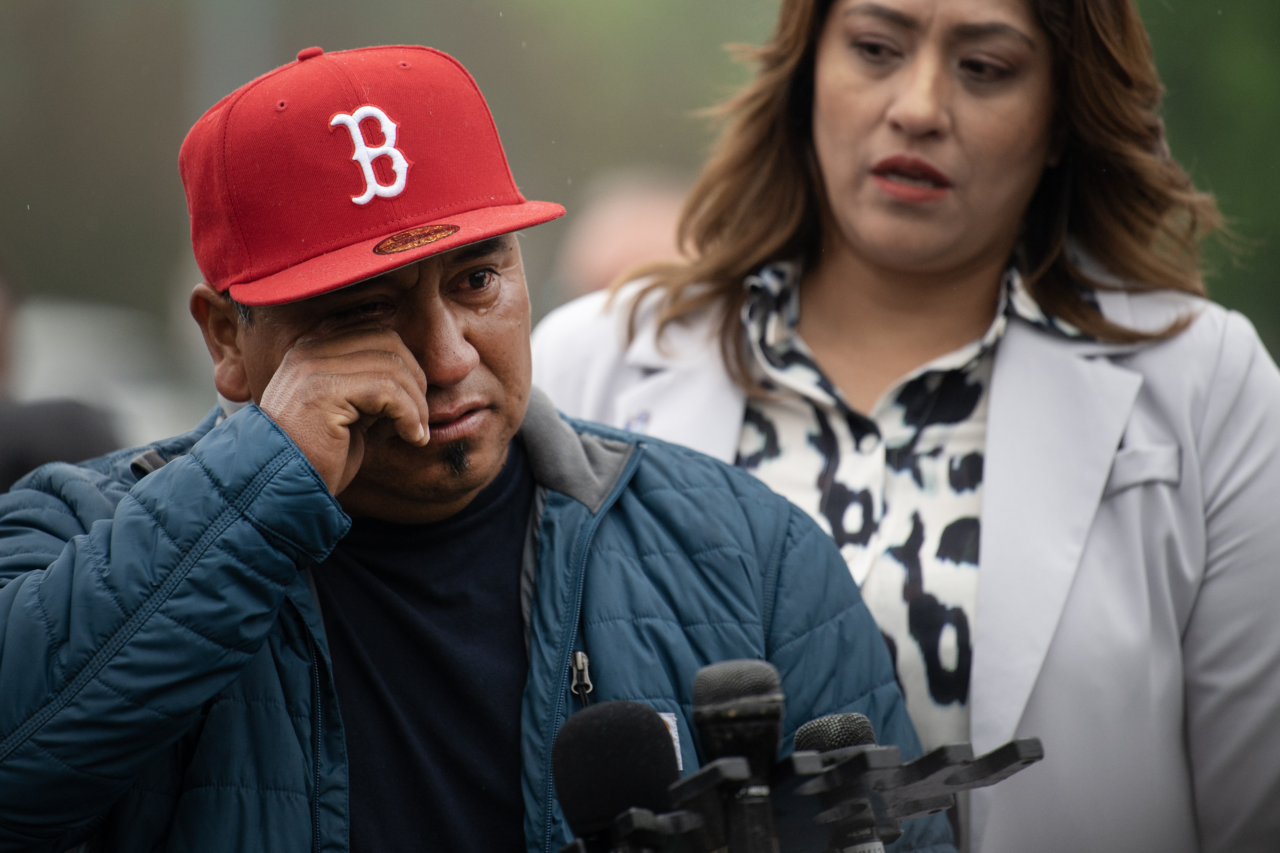 Santos Garcia, the father of Luis Garcia, who was shot on February 13th in front of East High School and died two weeks later from his injuries, wipes away tears as he recounts the last conversation he had with his son, while Barringer Law Firm office manager Aida Montanez provides translation during a press conference in front of the Thatcher Memorial Fountain on Friday, May 19, 2023, at City Park in Denver. (Timothy Hurst/Denver Gazette) (TimHursttim.hurst@gazette.comhttps://secure.gravatar.com/avatar/aca82bd62b4ee425c598527cd6faa1b1?d=mm&r=g)