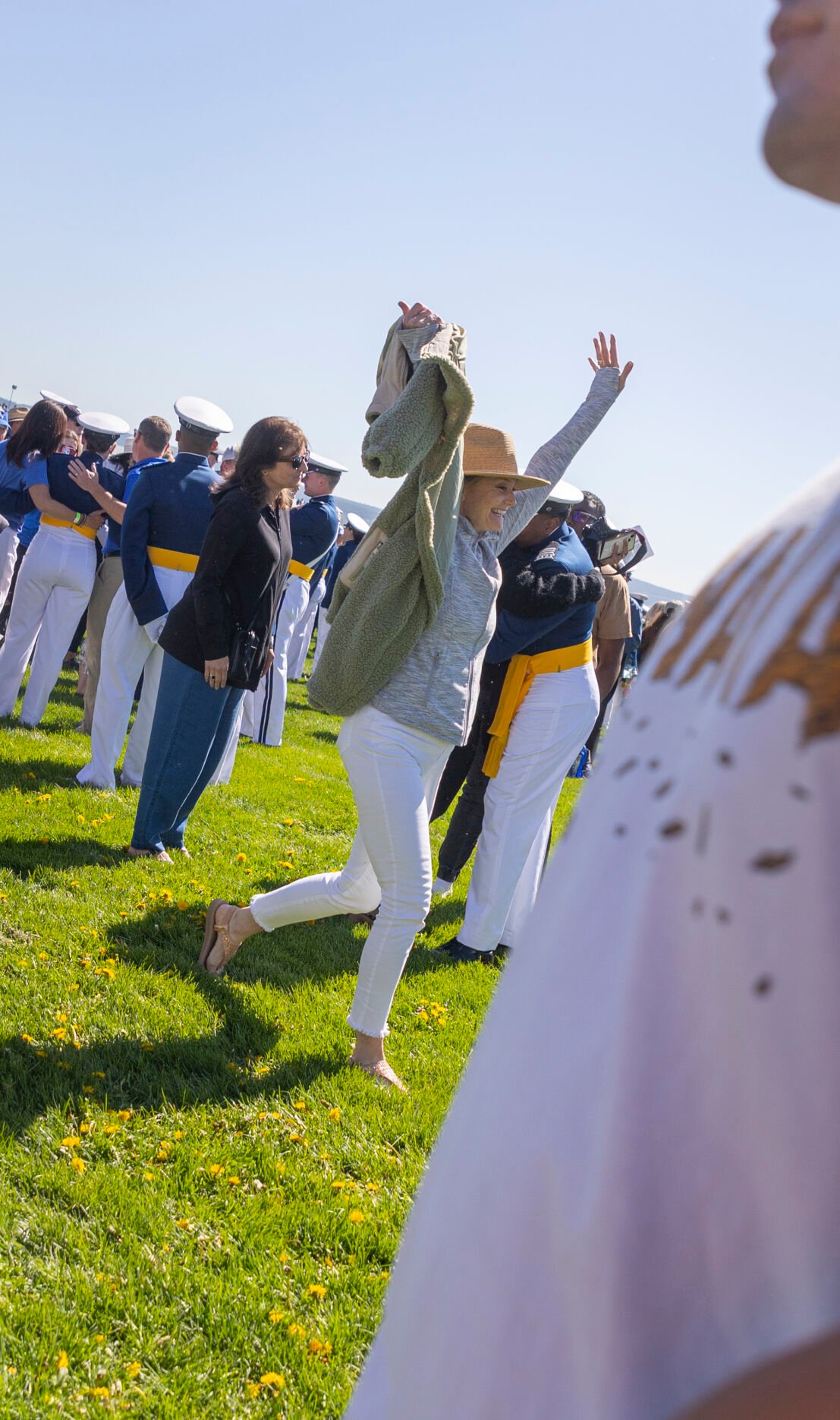 Graduating cadets’ friends and family rush Stillman Field to, ‘tap out,’ their graduate after the U.S. Air Force Academy Class of 2023 Graduation Parade in Colorado Springs, Co., on Wednesday, May 31, 2023. ‘Tapping out,’ is a tradition where the cadet’s family must tap them in order to put them at ease after the parade. (Gabi Broekema)