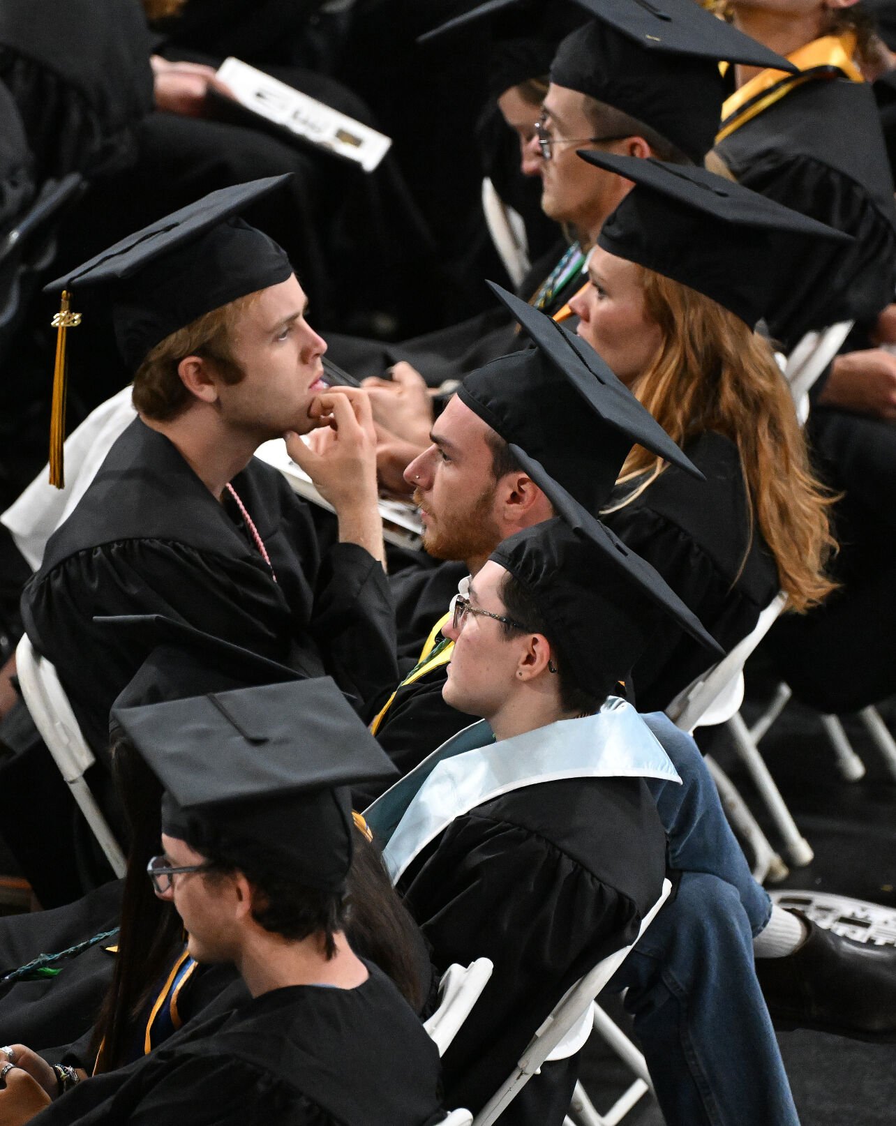 A student listens to the speech of Colorado College alumna and former U.S. Rep. Liz Cheney, R-Wyo. Liz Cheney while most of the students in around him turned their back to her during the Colorado College graduation ceremony on Sunday, May 28, 2023. (Photo by Jerilee Bennett, The Gazette)