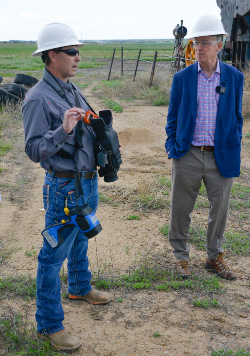 Oil well plugging and remediation company Greenfields Environmental Solutions CEO Michael Rigg explains advanced equipment used to detect and quantify methane leaks to Colorado Sen. John Hickenlooper during a tour of an abandoned “orphan” oil well site. The well will be capped and permanently sealed and the well site restored by Greenfield as part of a public-private partnership spearheaded by Denver’s Civitas Resources, which is sponsoring the cleanup of 42 of some 300 abandoned wells in Adams County, Colo.