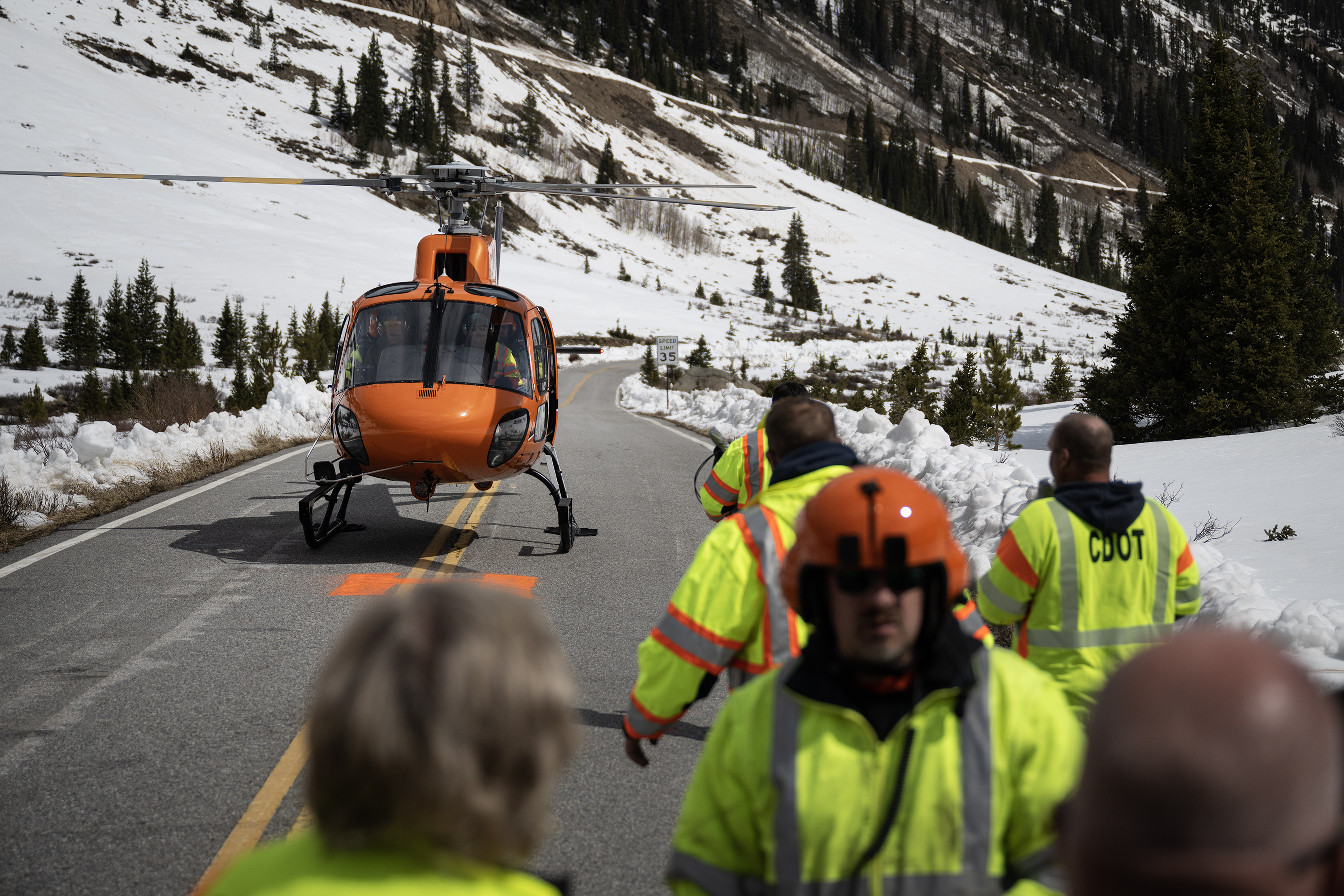 A Colorado Department of Transportation crew members carry explosives referred to as “turkey bombs” to a crew in the helicopter before it heads to the saddle of the mountain to blast the overhanging snow slab and trigger an avalanche during a mission to conduct avalanche mitigation off Colorado 82 on the east side of Independence Pass on Tuesday, May 2, 2023, in Lake County, Colo. (Timothy Hurst/Denver Gazette) (TimHursttim.hurst@gazette.comhttps://secure.gravatar.com/avatar/aca82bd62b4ee425c598527cd6faa1b1?d=mm&r=g)