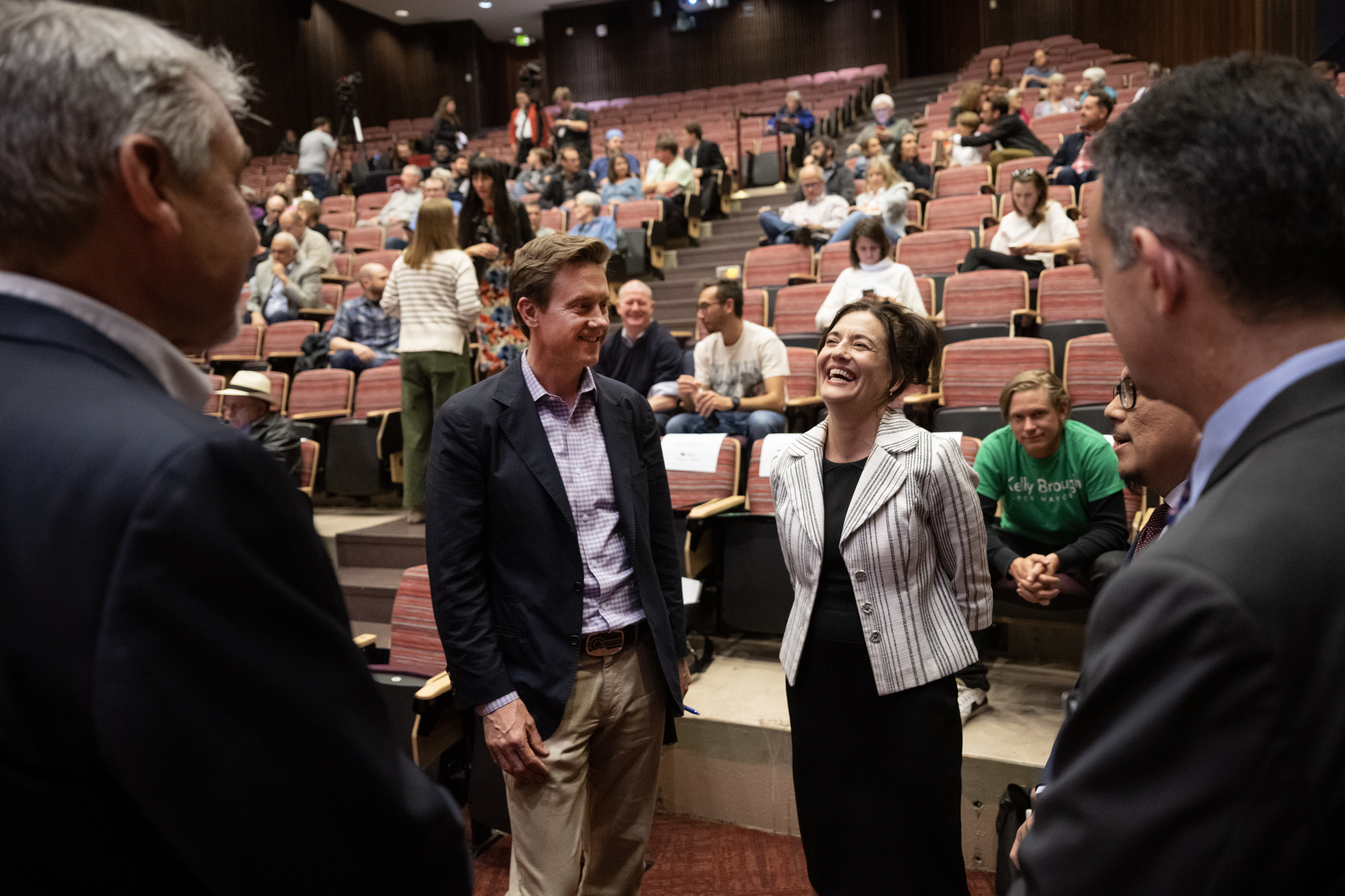 Denver mayoral run-off candidates Mike Johnston, left, and Kelly Brough, share a laugh as Colorado Politics and Denver Gazette editor Luige Del Puerto prepares to flip a coin to decide who will answer first for the first question in a debate on Thursday, May 18, 2023, in the Sam & Freda Davis Auditorium at the University of Denver in Denver, Colo. (Timothy Hurst/Denver Gazette) (TimHursttim.hurst@gazette.comhttps://secure.gravatar.com/avatar/aca82bd62b4ee425c598527cd6faa1b1?d=mm&r=g)