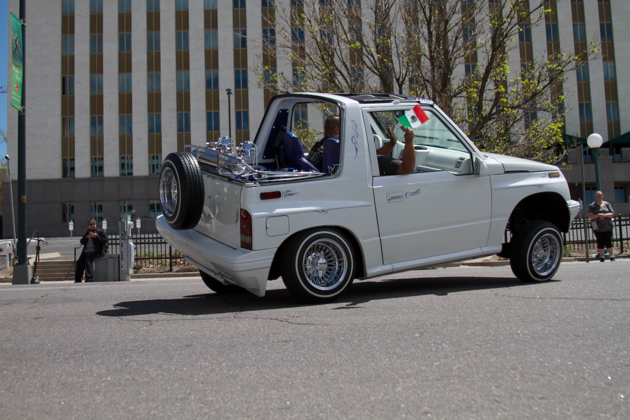 The same car as it passes with the Mexican flag visible out of the window on May 6, 2023. (Alex Edwards/The Denver Gazette).