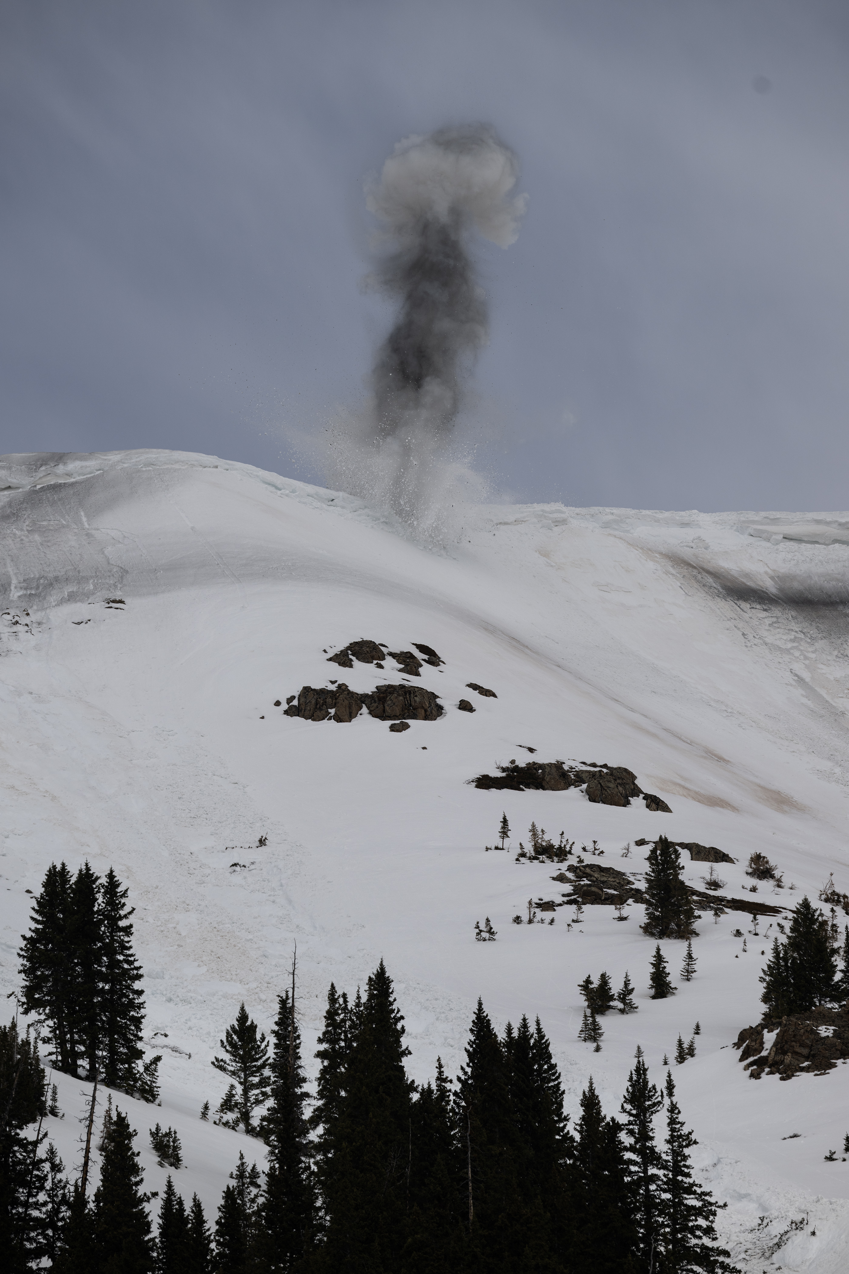 An explosive referred to as a “turkey bomb” goes off, triggering the snow slab overhanging the slope above Colorado 82 to fall and create an manmade avalanche on the east side of Independence Pass while Colorado Department of Transportation and Colorado Avalanche Information Center crews conduct mitigation work in preparation to clear the road for its opening later this month, as seen on Tuesday, May 2, 2023, in Lake County, Colo. (Timothy Hurst/Denver Gazette) (TimHursttim.hurst@gazette.comhttps://secure.gravatar.com/avatar/aca82bd62b4ee425c598527cd6faa1b1?d=mm&r=g)