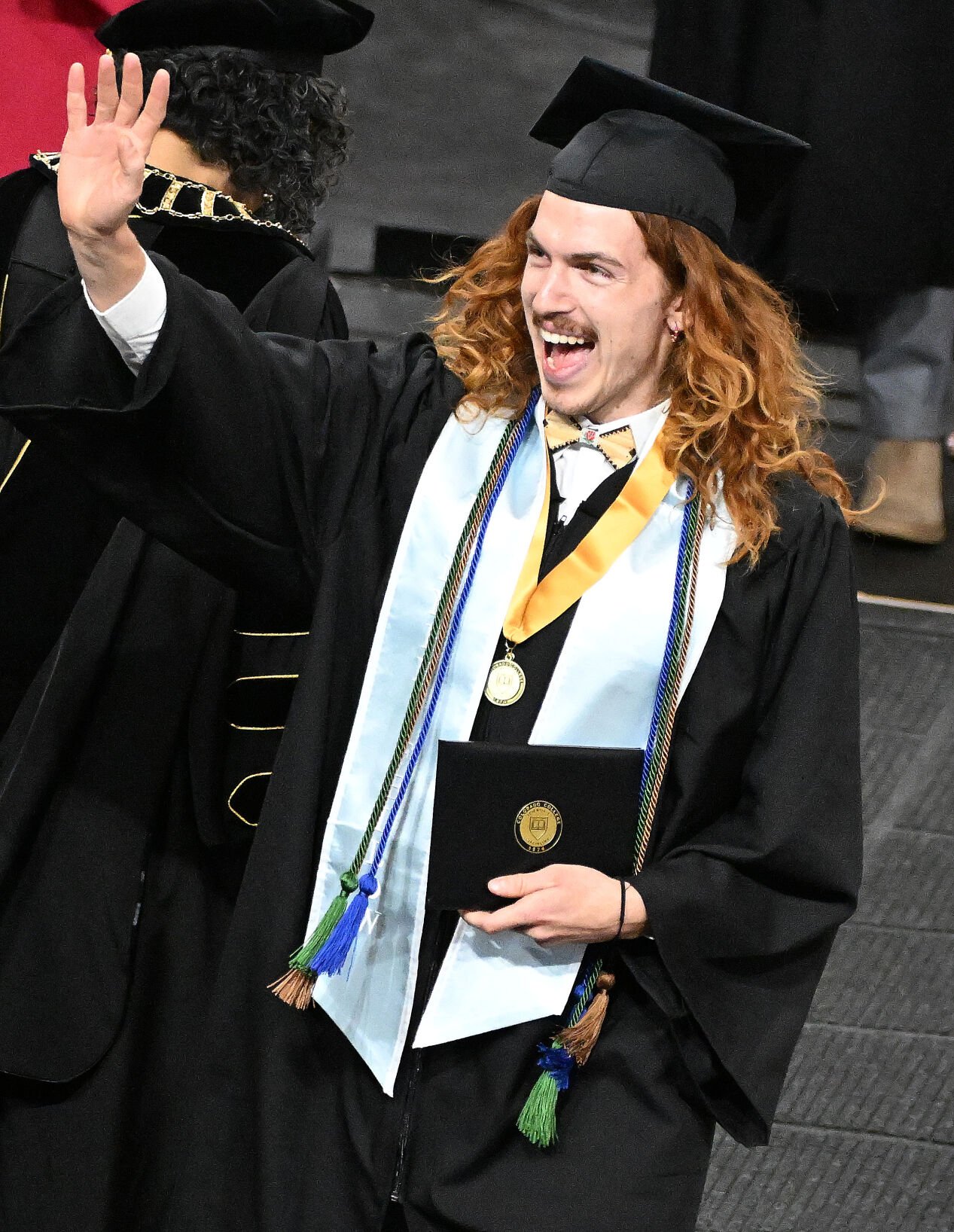 One Colorado College graduating student waves to his family as he happily accepts his diploma. (Photo by Jerilee Bennett, The Gazette)