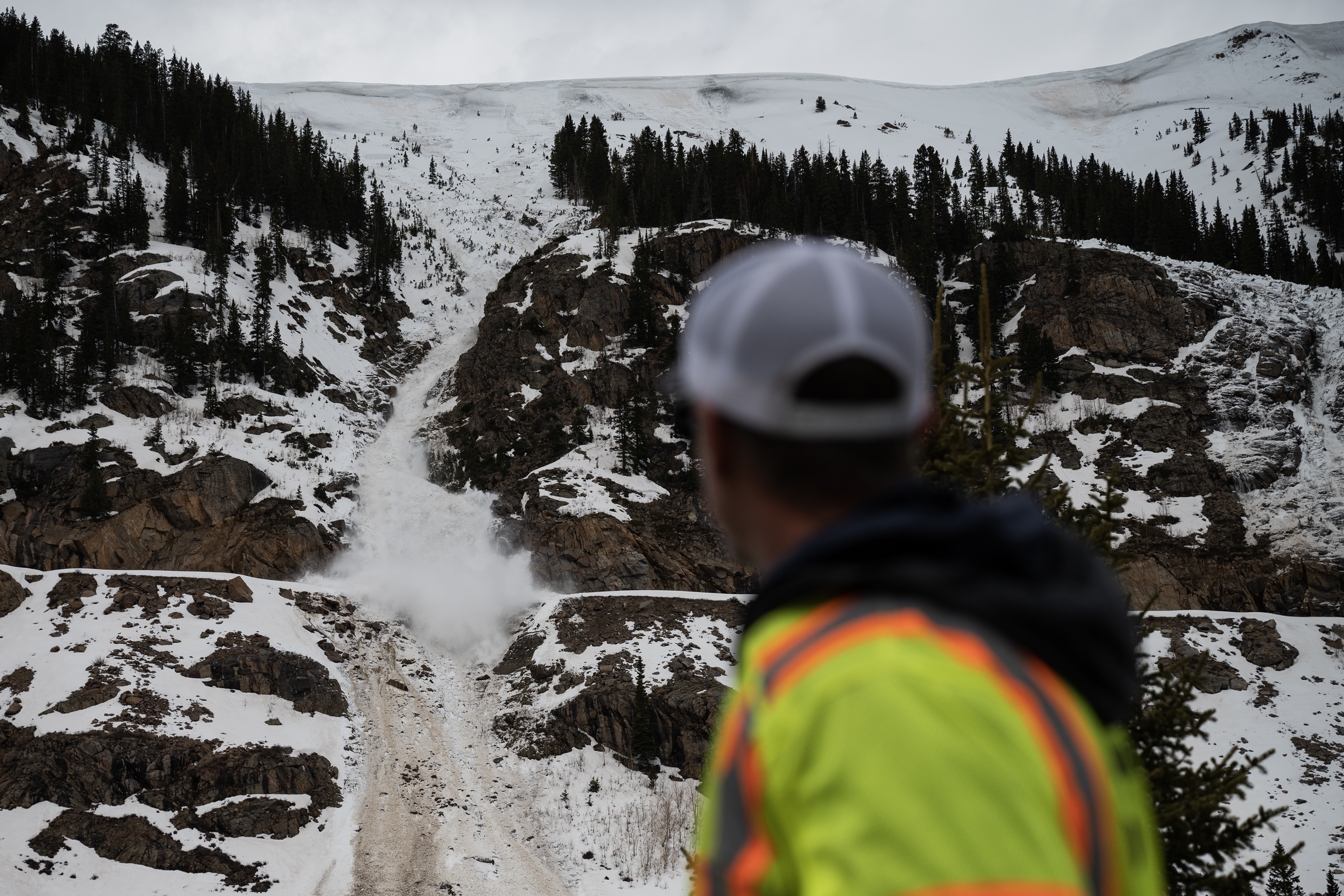 Colorado Department of Transportation state avalanche coordinator Brian Gorsage looks on as an avalanche, purposefully triggered by CDOT and Colorado Avalanche Information Center crews for mitigation work, slides down and over Colorado 82 on the east side of Independence Pass on Tuesday, May 2, 2023, in Lake County, Colo. Crews are working to clear the highway in anticipation for its expected opening later this month. (Timothy Hurst/Denver Gazette) (TimHursttim.hurst@gazette.comhttps://secure.gravatar.com/avatar/aca82bd62b4ee425c598527cd6faa1b1?d=mm&r=g)