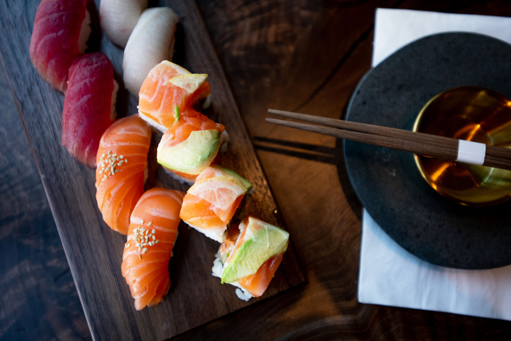 An assortment of sushi and one of Sushi Row’s house rolls, the Kobra Kai, are pictured.
