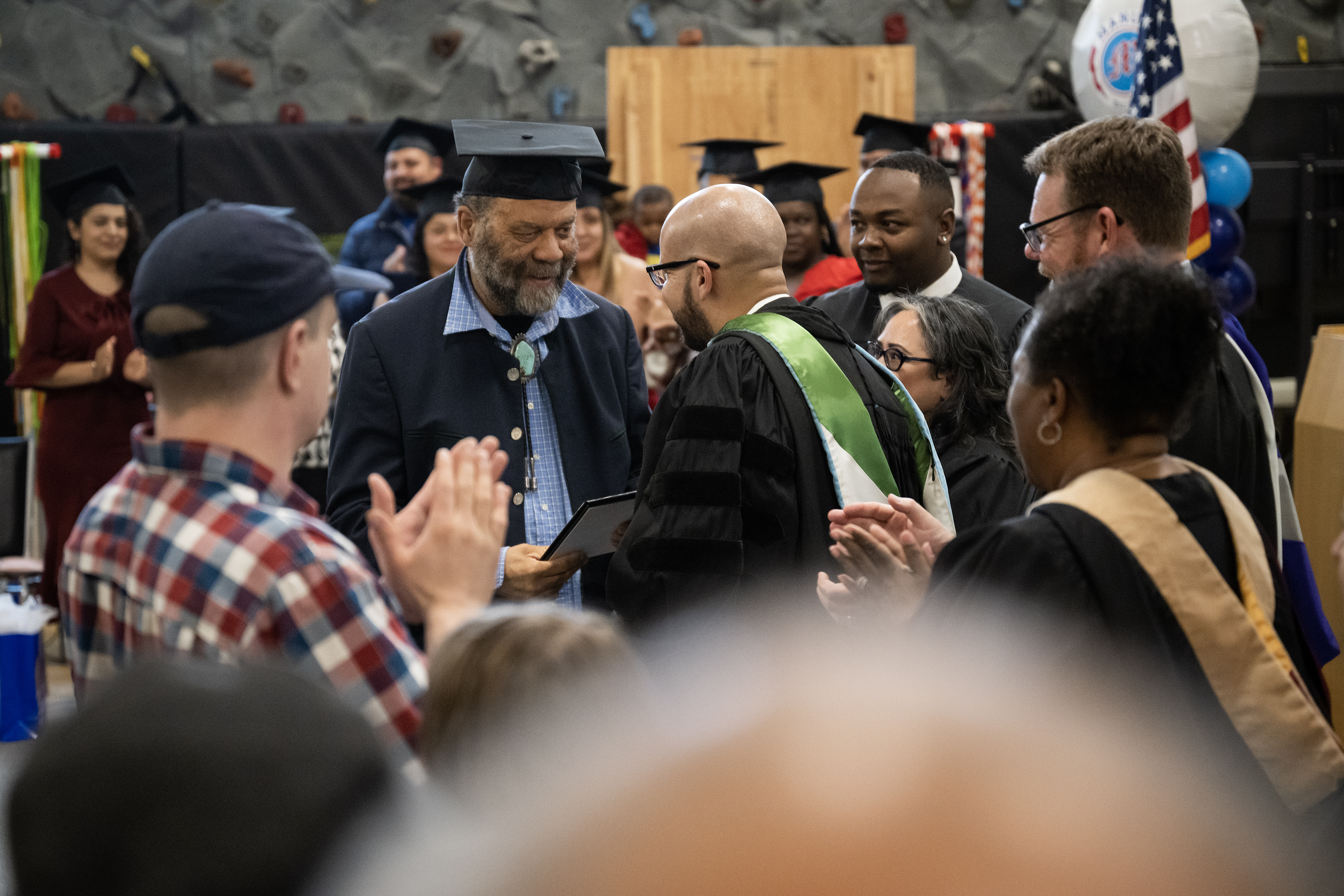 Denver Blues legend Otis Taylor, center, shakes hand with Denver Public Schools superintendent Alex Marrero after receiving his degree 57 years after being expelled for refusing to trim his afro, during a graduation ceremony where the DPS board would confer degrees to students who’s education was disrupted by the closing of Manual High School in 2006, as well as confer a degree to Taylor on Monday, May 15, 2023, during a Denver Public Schools Board of Education meeting in Denver. (Timothy Hurst/Denver Gazette) (TimHursttim.hurst@gazette.comhttps://secure.gravatar.com/avatar/aca82bd62b4ee425c598527cd6faa1b1?d=mm&r=g)