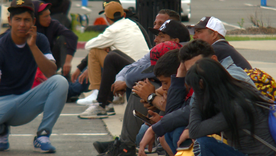 Immigrants waiting near Denver parking garage