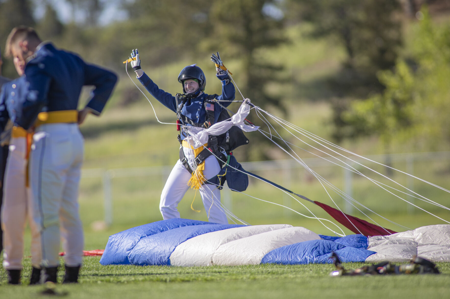 Graduating cadet Baileigh McFall cheers after successfully parachuting onto Stillman Field at the U.S. Air Force Academy Class of 2023 Graduation Parade in Colorado Springs, Co., on Wednesday, May 31, 2023. (Gabi Broekema)