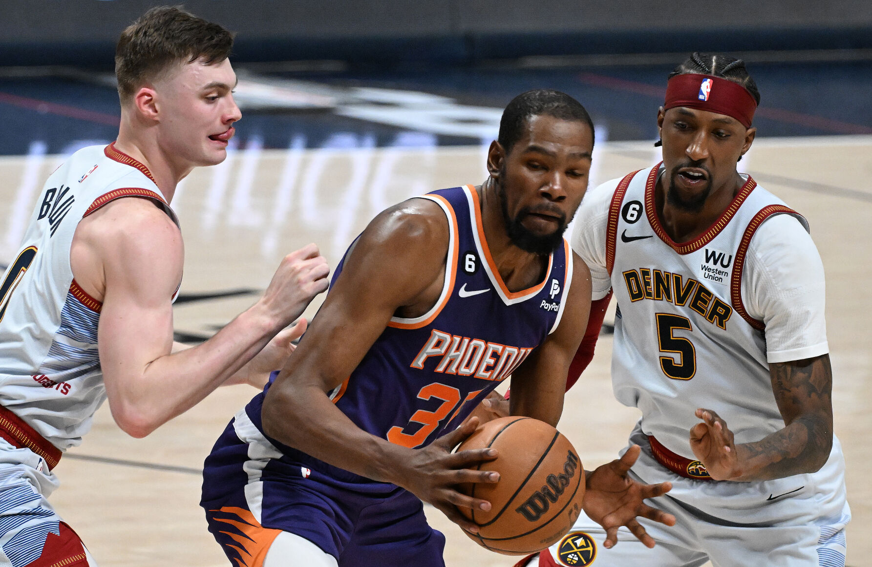 Nuggets Christian Braun and Kentavious Caldwell-Pope defends Suns Kevin Durant during the second quarter of the game 5 of the second round of the NBA playoffs at Ball Arena on Tuesday, May 9, 2023. (Photo by Jerilee Bennett, The Gazette)
