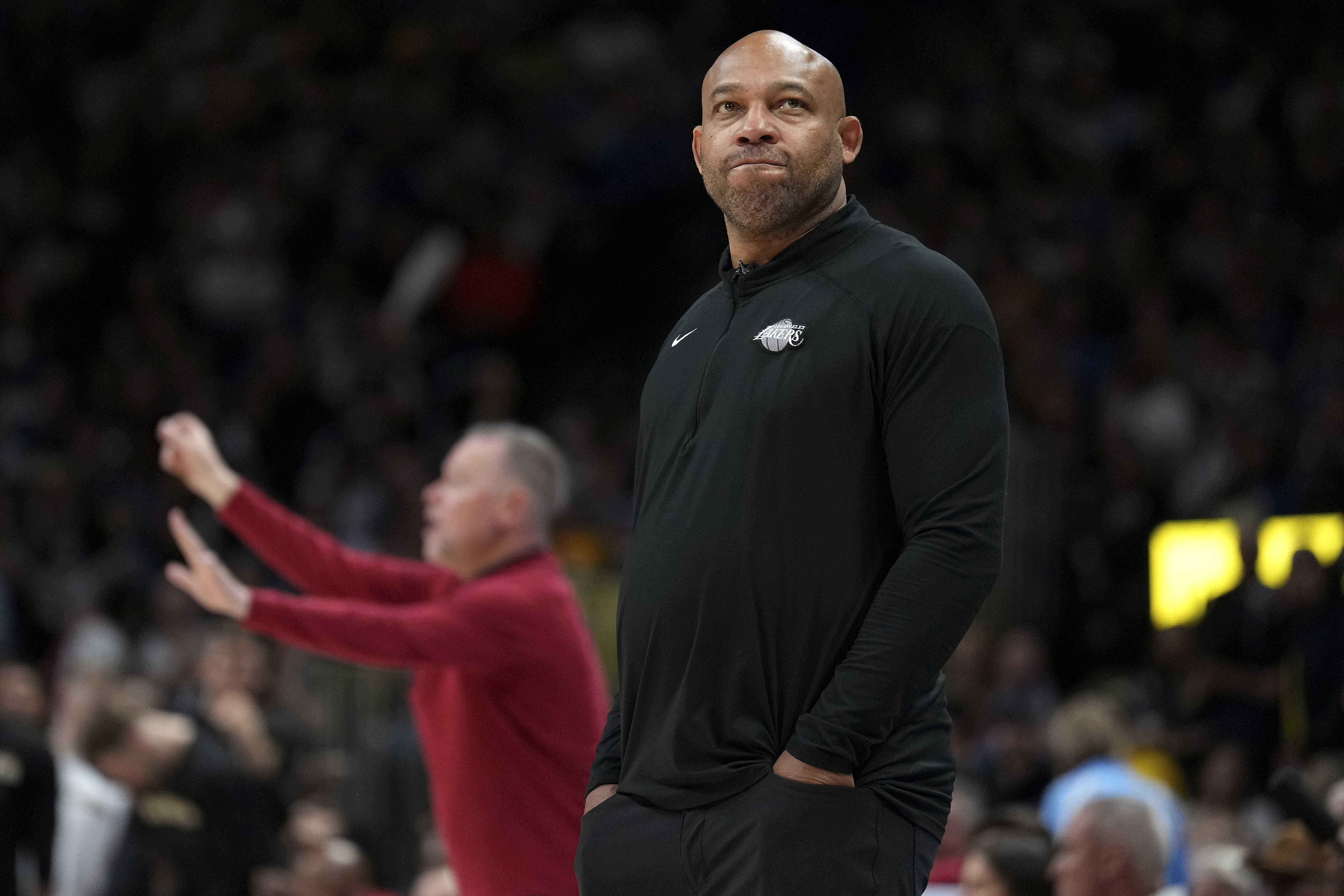 Los Angeles Lakers head coach Darvin Ham looks away as Denver Nuggets head coach Michael Malone yells in the background during the first half of Game 2 of the NBA basketball Western Conference Finals series, Thursday, May 18, 2023, in Denver. (AP Photo/Jack Dempsey) (Jack Dempsey)
