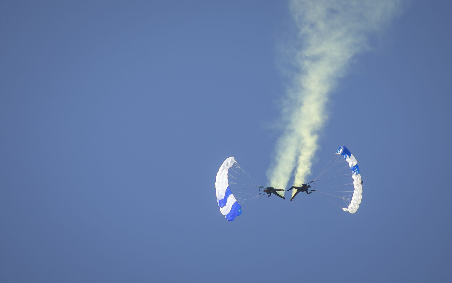 Two cadets of the Wings of Blue descend feet to feet to begin their graduation celebration at the U.S. Air Force Academy Class of 2023 Graduation Parade at Stillman Parade Field of the U.S. Air Force Academy in Colorado Springs, Co., on Wednesday, May 31, 2023. (Gabi Broekema)