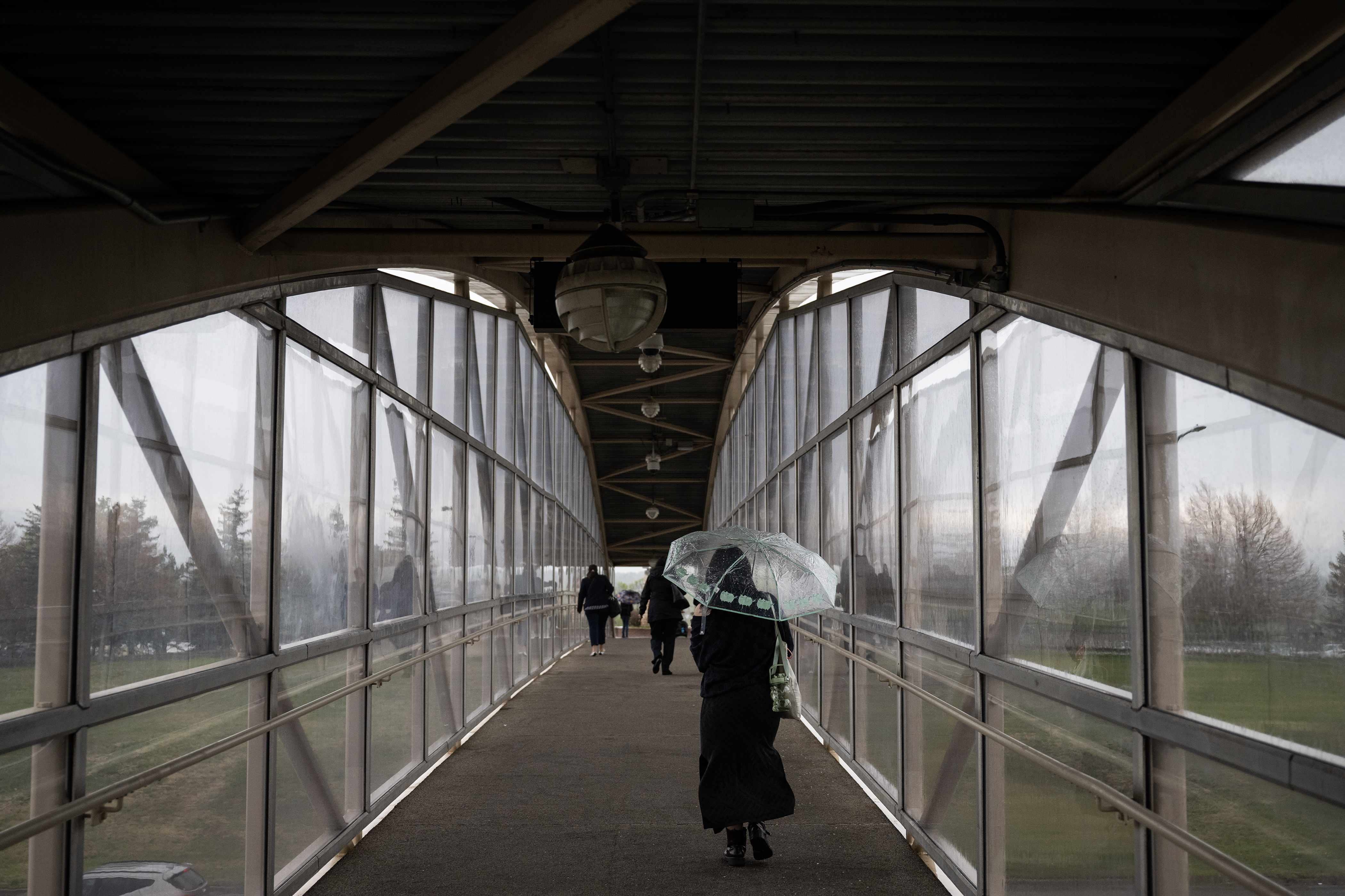 Nova, no last name given, a students returning home from school, keeps her umbrella handy after exiting her train in a rainstorm on Wednesday afternoon, May 10, 2023, at the RTD light rail Mineral Station in Littleton, Colo. (Timothy Hurst/Denver Gazette) (TimHursttim.hurst@gazette.comhttps://secure.gravatar.com/avatar/aca82bd62b4ee425c598527cd6faa1b1?d=mm&r=g)
