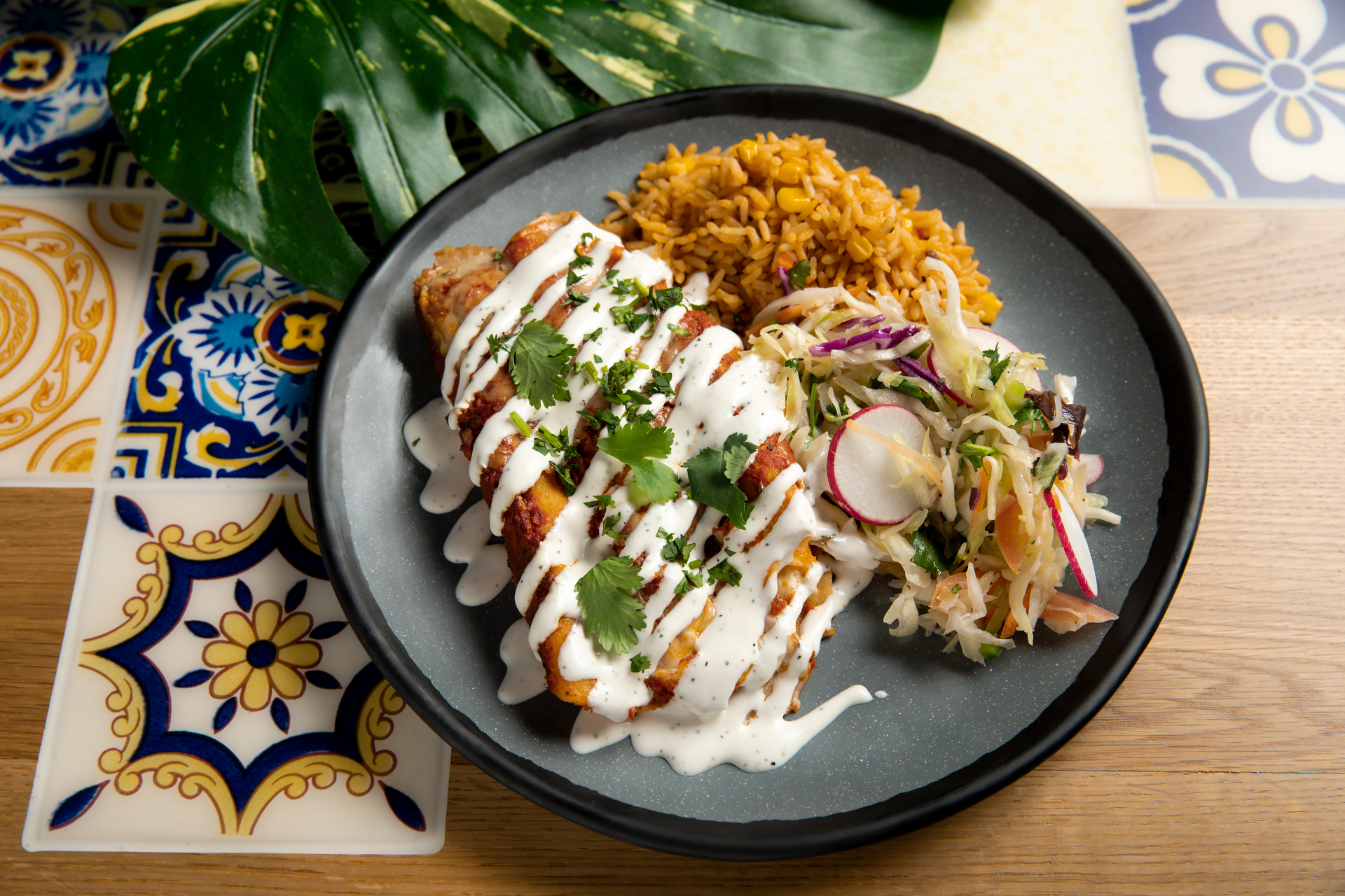 A plate featuring Casa Bonita’s Red Chile Enchilada entree shown here in a photo released May 26, 2023 by the restaurant. (Jennifer Olson/Casa Bonita)