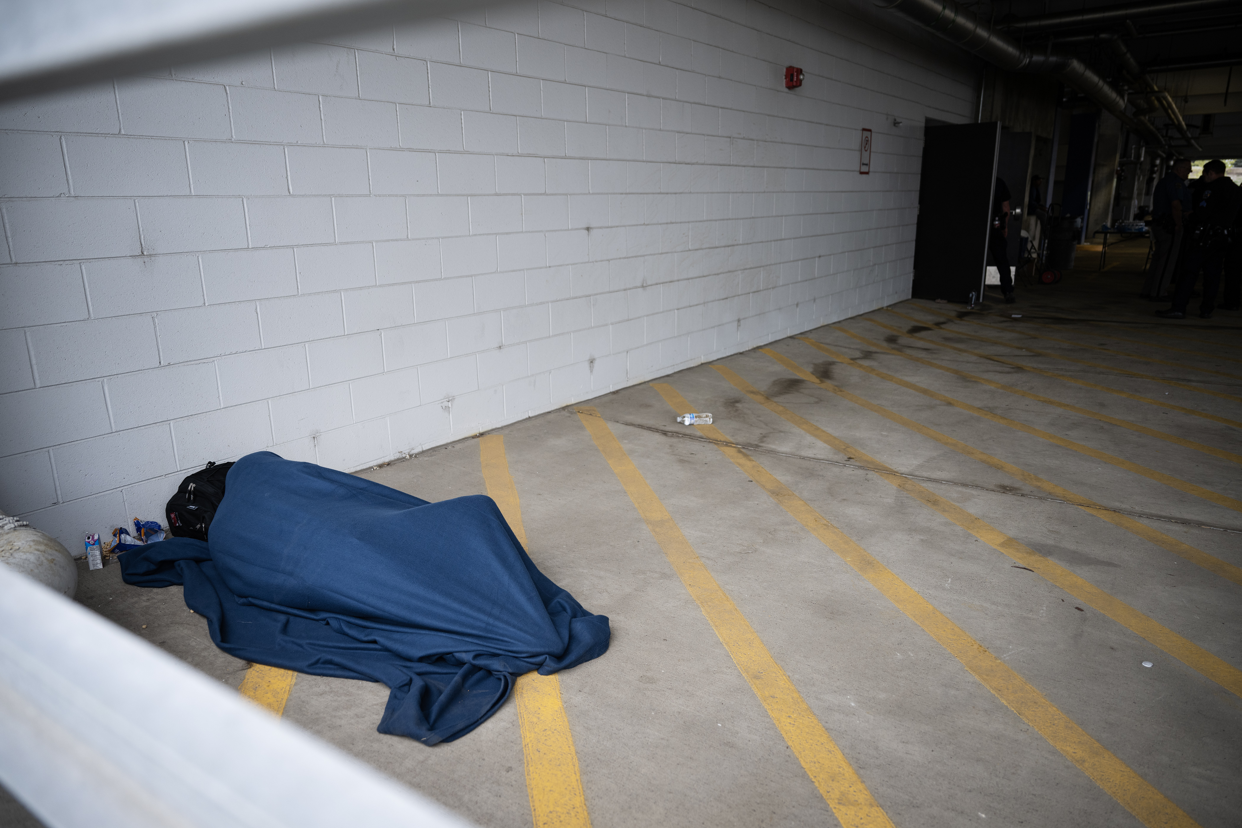 An immigrant tries to sleep in the corner of a blocked-off parking garage on Wednesday, May 10, 2023, on the Auraria Campus in Denver. (Timothy Hurst/Denver Gazette) (TimHursttim.hurst@gazette.comhttps://secure.gravatar.com/avatar/aca82bd62b4ee425c598527cd6faa1b1?d=mm&r=g)