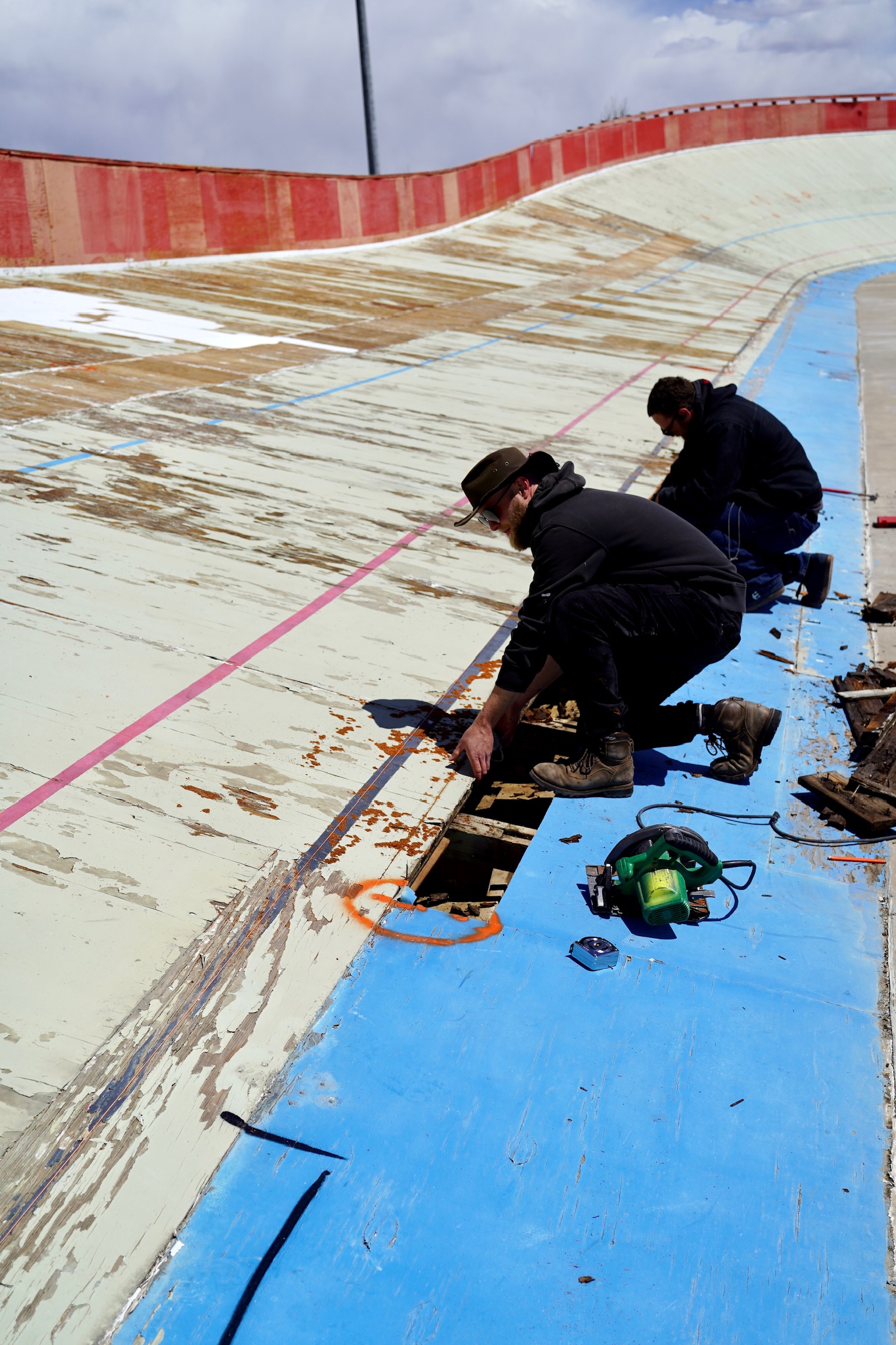 Todd Stevenson of Team Colorado Cycling (right) and Rory Pariseau with Vertical Construction work on the Boulder Valley Velodrome track, Thursday, April 20, 2023 in Erie, Colorado. (Courtesy Boulder Valley Velodrome/OnSight Public Affairs)