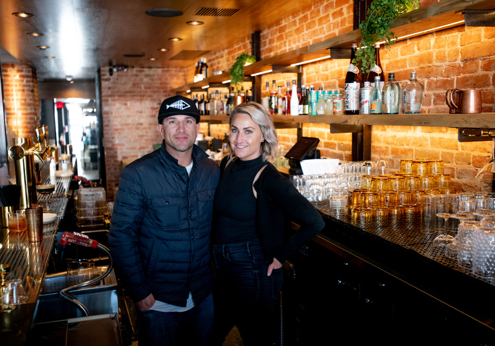 Sushi Row owners Jason Wallenta and his wife, Riley O’Brien, pose for a portrait in the restaurant Thursday. The Sushi Row concept has been a “passion project” for the pair for years, he said. (Parker Seibold, The gazette)