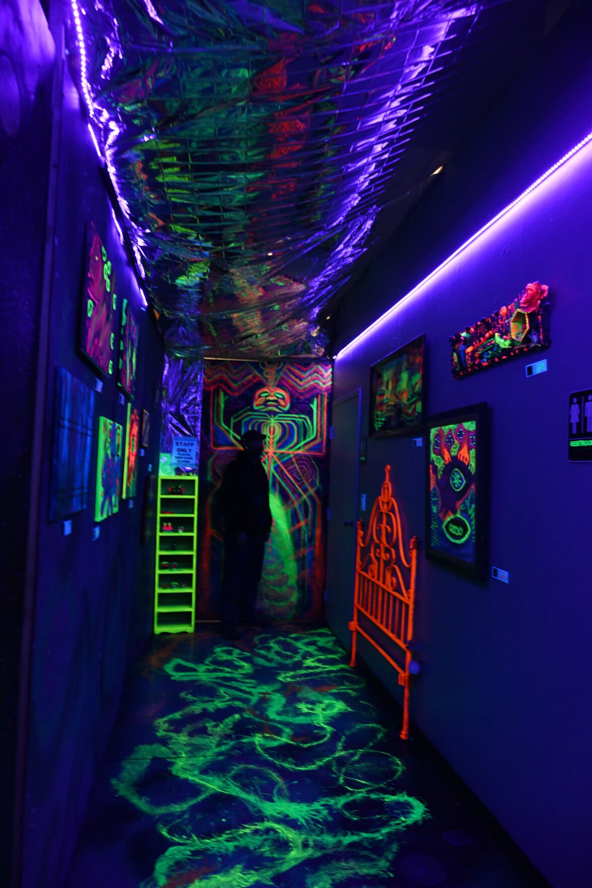 Left: The hallway at LightSpeed Curations has a permanent black light display. (Photos by Jerilee Bennett, The Gazette)