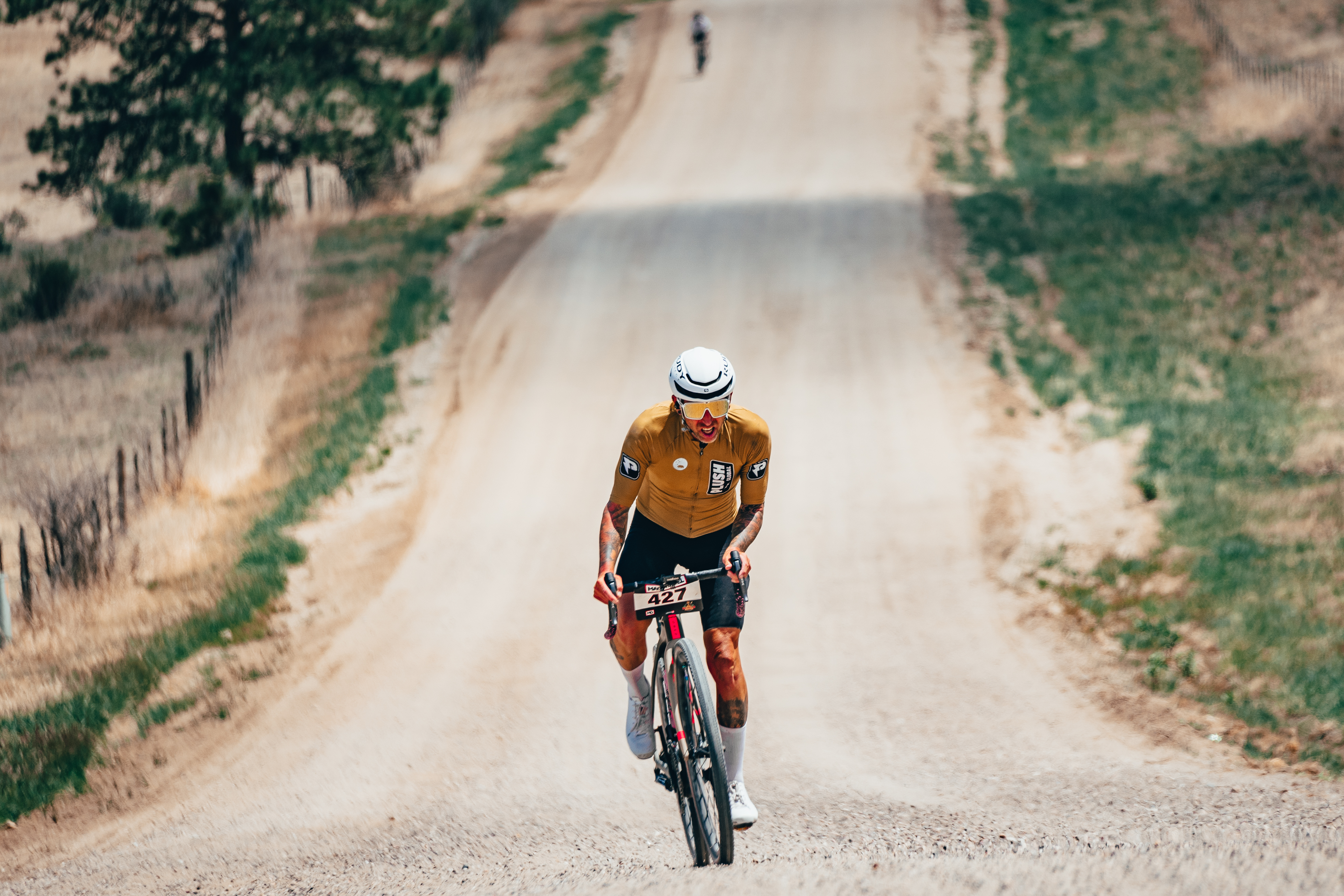 A gravel bike rider ascends a dirt road during a Mad Gravel race in Elbert, County in May 2022. (Courtesy, BeFeral Media)