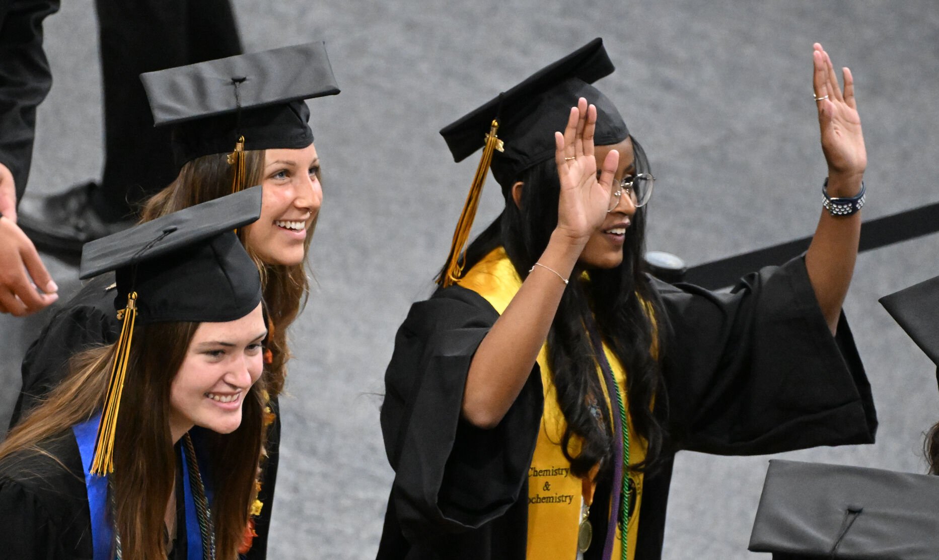 Students smile to friends and relatives as they enter Ed Robson Arena for they graduation ceremony. (Photo by Jerilee Bennett, The Gazette)