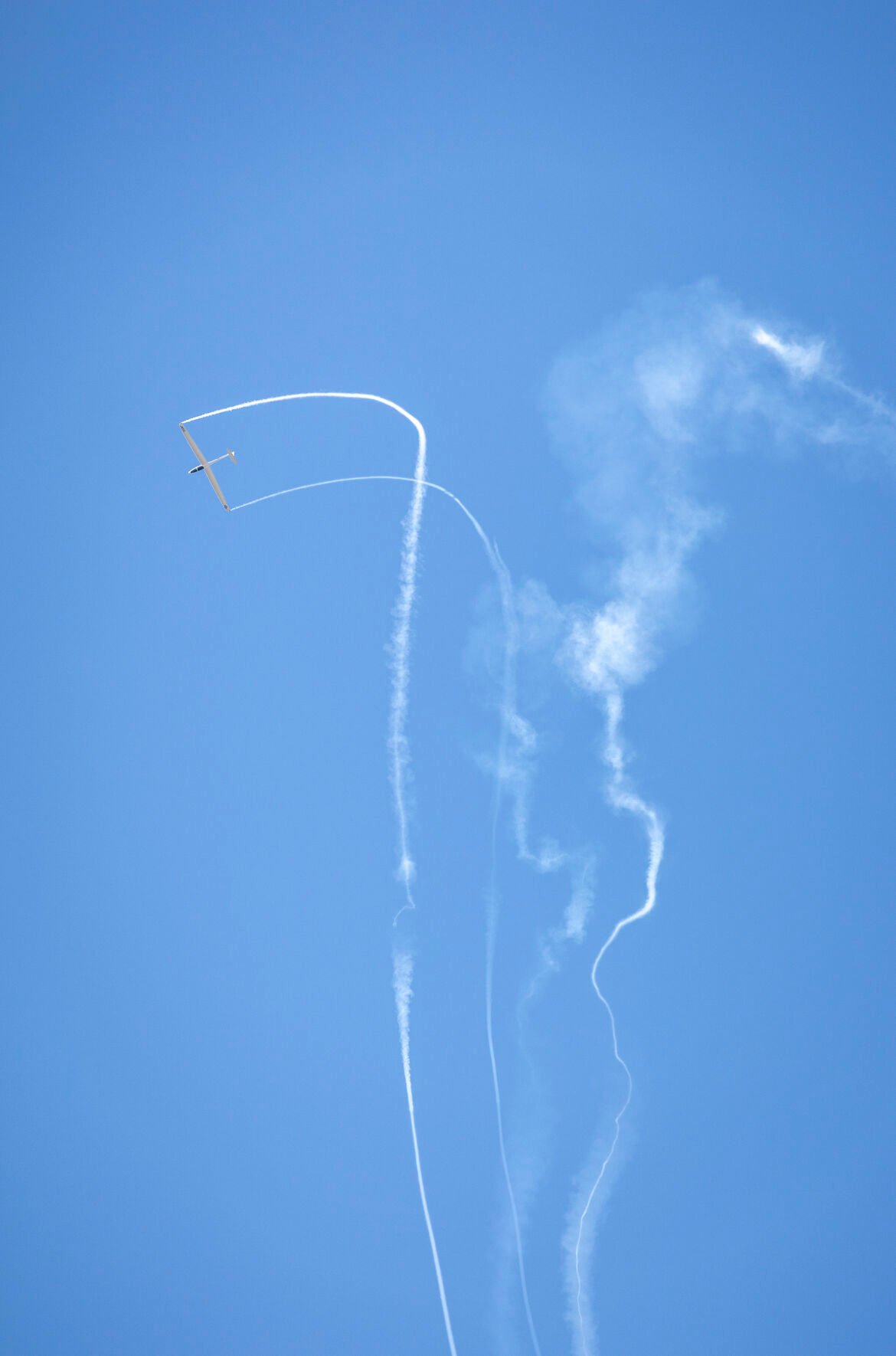 A cadet-flow aircraft winds through its own smoke trail before the U.S. Air Force Academy Class of 2023 Graduation Parade at Stillman Field in Colorado Springs, Co., on Wednesday, May 31, 2023. (Gabi Broekema)