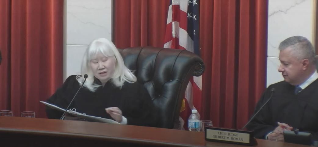 Judge Sueanna P. Johnson speaks on June 30, 2022 after her formal swearing-in to the Colorado Court of Appeals, with Chief Judge Gilbert M. Román at right.