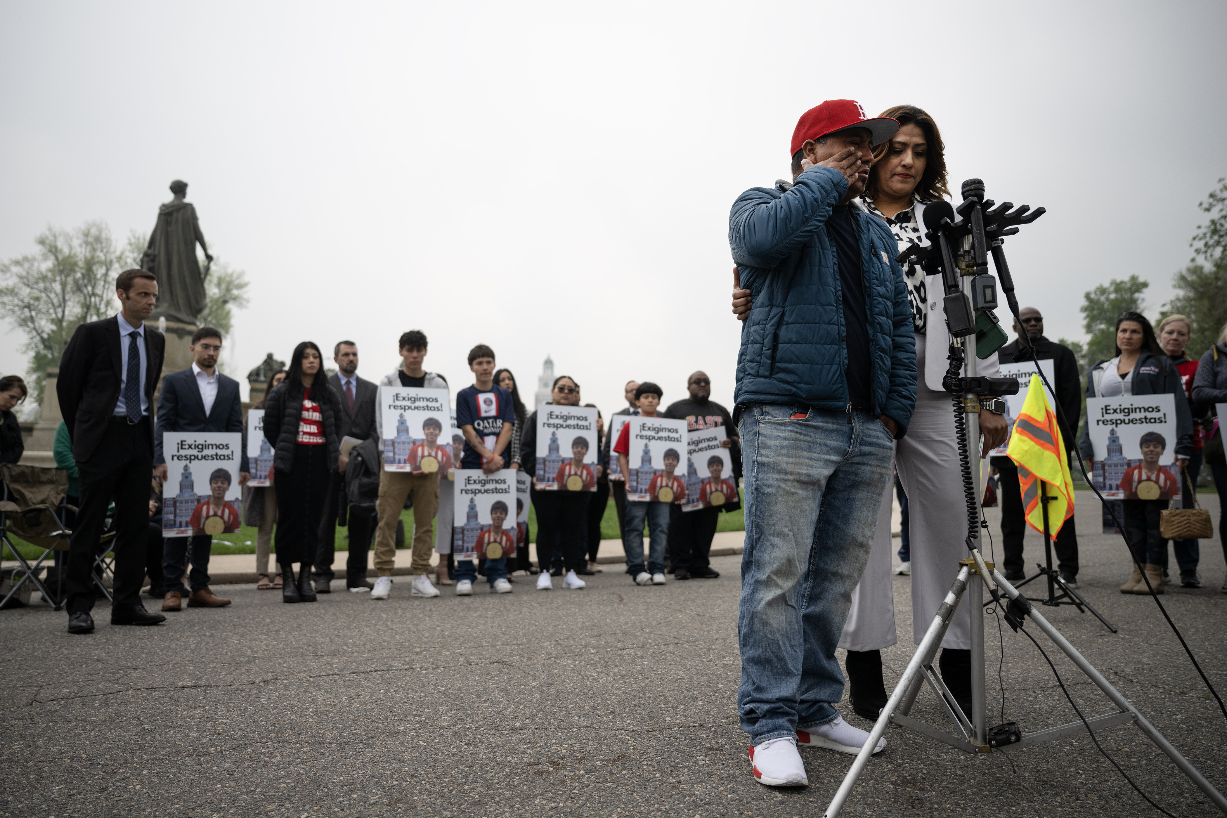 Santos Garcia, the father of Luis Garcia, who was shot on February 13th in front of East High School and died two weeks later from his injuries, wipes away tears as he recounts the last conversation he had with his son, while Barringer Law Firm office manager Aida Montanez provides interpretation during a press conference in front of the Thatcher Memorial Fountain on Friday, May 19, 2023, at City Park in Denver. (Timothy Hurst/Denver Gazette) (TimHursttim.hurst@gazette.comhttps://secure.gravatar.com/avatar/aca82bd62b4ee425c598527cd6faa1b1?d=mm&r=g)