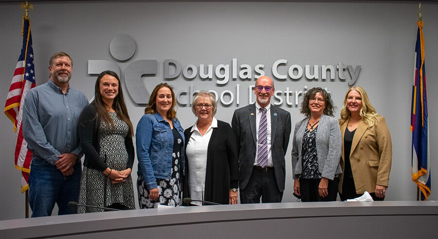 The Douglas County School District Board of Education — from left, Mike Peterson, Kaylee Winegar, Christy Williams, Becky Myers, David Ray, Susan Meek and Elizabeth Hanson — is sworn in Nov. 29. Hanson resigned abruptly during a meeting Tuesday. (via dcsdk12.org)