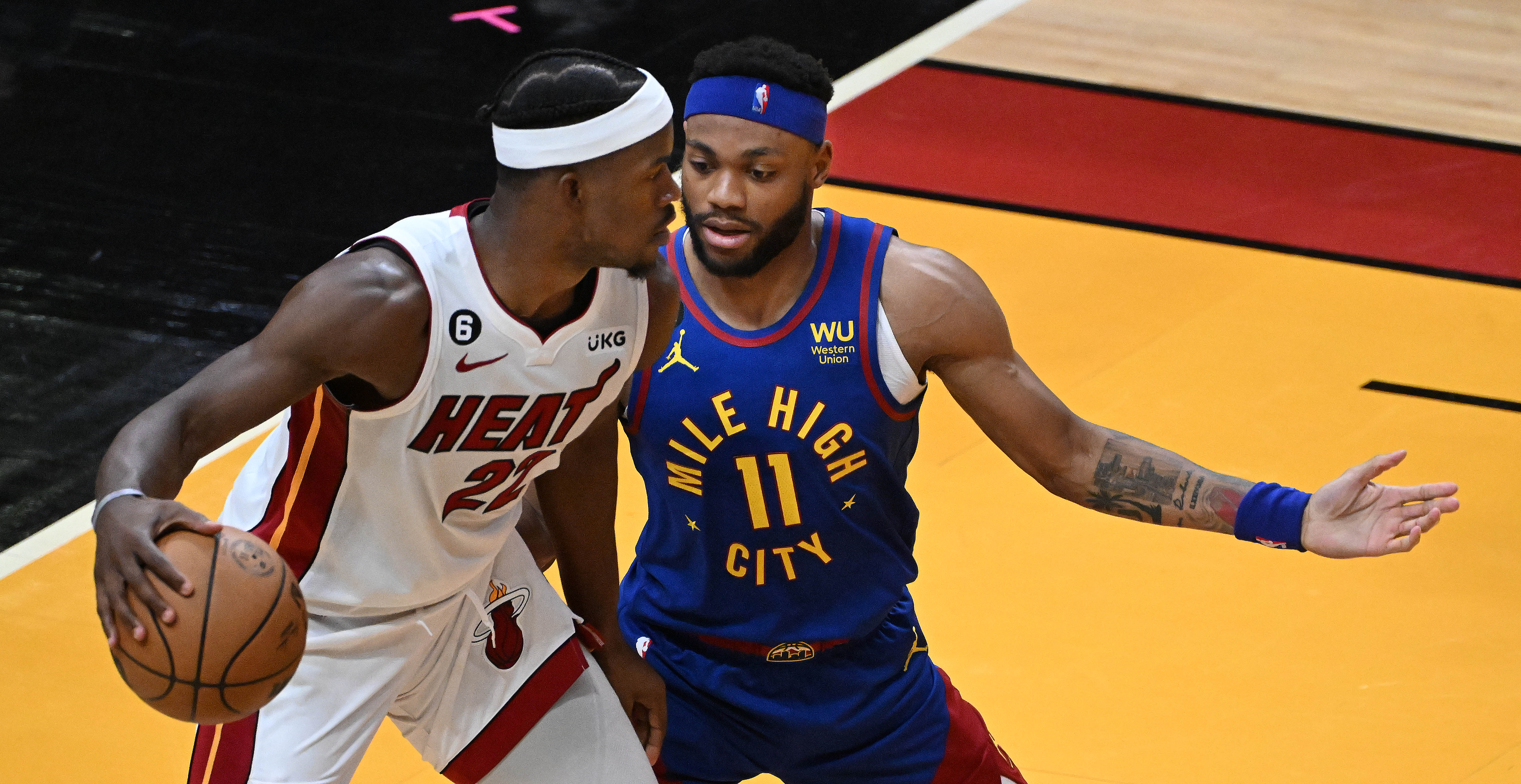 Denver Nuggets forward Bruce Brown (11) puts pressure on Miami Heat forward Jimmy Butler (22) in the 4th quarter of the game 3 at at the Kaseya Center in Miami during the first quarter of Game 3 of the NBA Finals on Wednesday, June 7, 2023. (Photo by Jerilee Bennett, The Gazette)