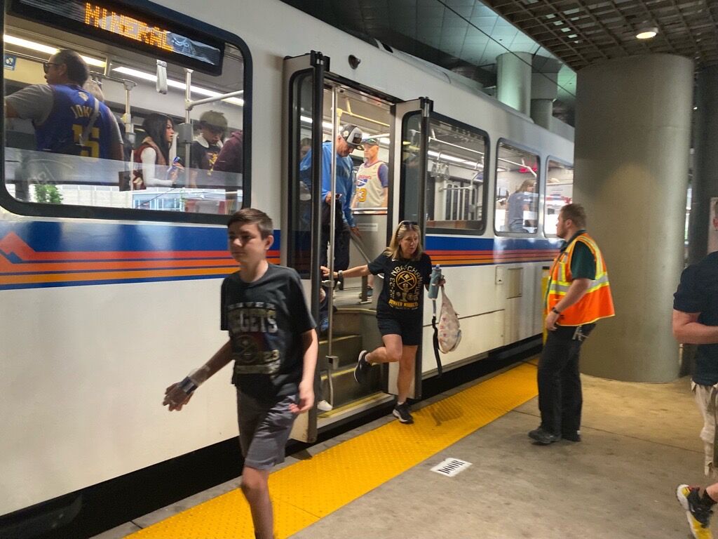 Young fans arrive off the light rail before the Denver Nuggets parade on the streets of Denver. (Carol McKinley, Denver Gazette)