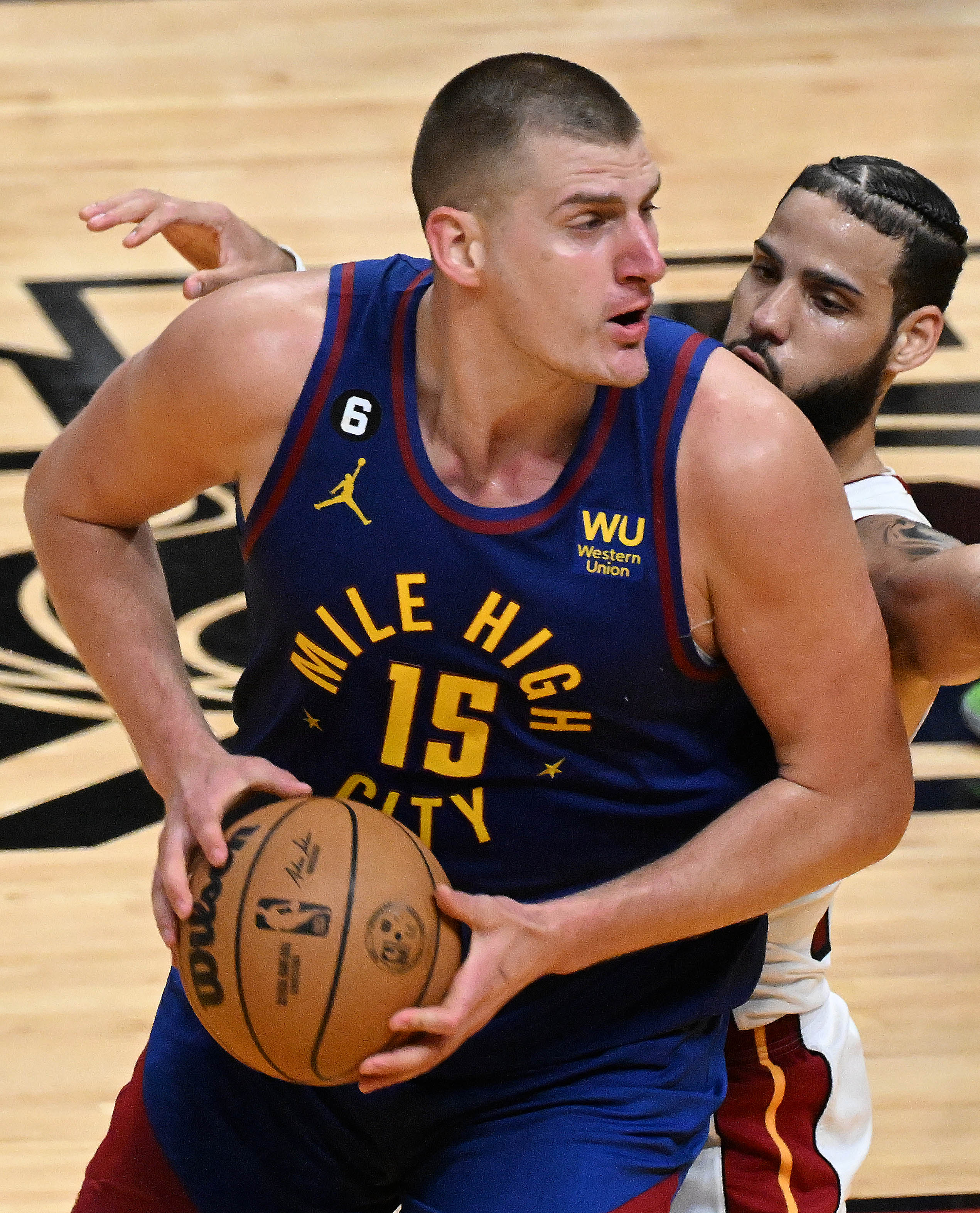 Denver Nuggets center Nikola Jokic (15) is defended by Miami Heat forward Caleb Martin (16) during game 3 at Kaseya Center in Miami on Wednesday, June 7, 2023. (Photo by Jerilee Bennett, The Gazette)