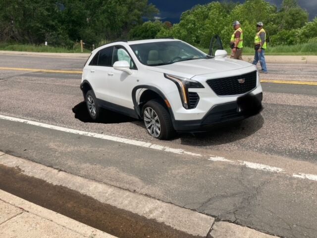 An SUV was driving along Mineral Avenue near JackAss Road in Littleton when the street collapsed causing minor damage to the vehicle. Littleton Public Works shut down the area to do repairs. (Littleton Police Department)