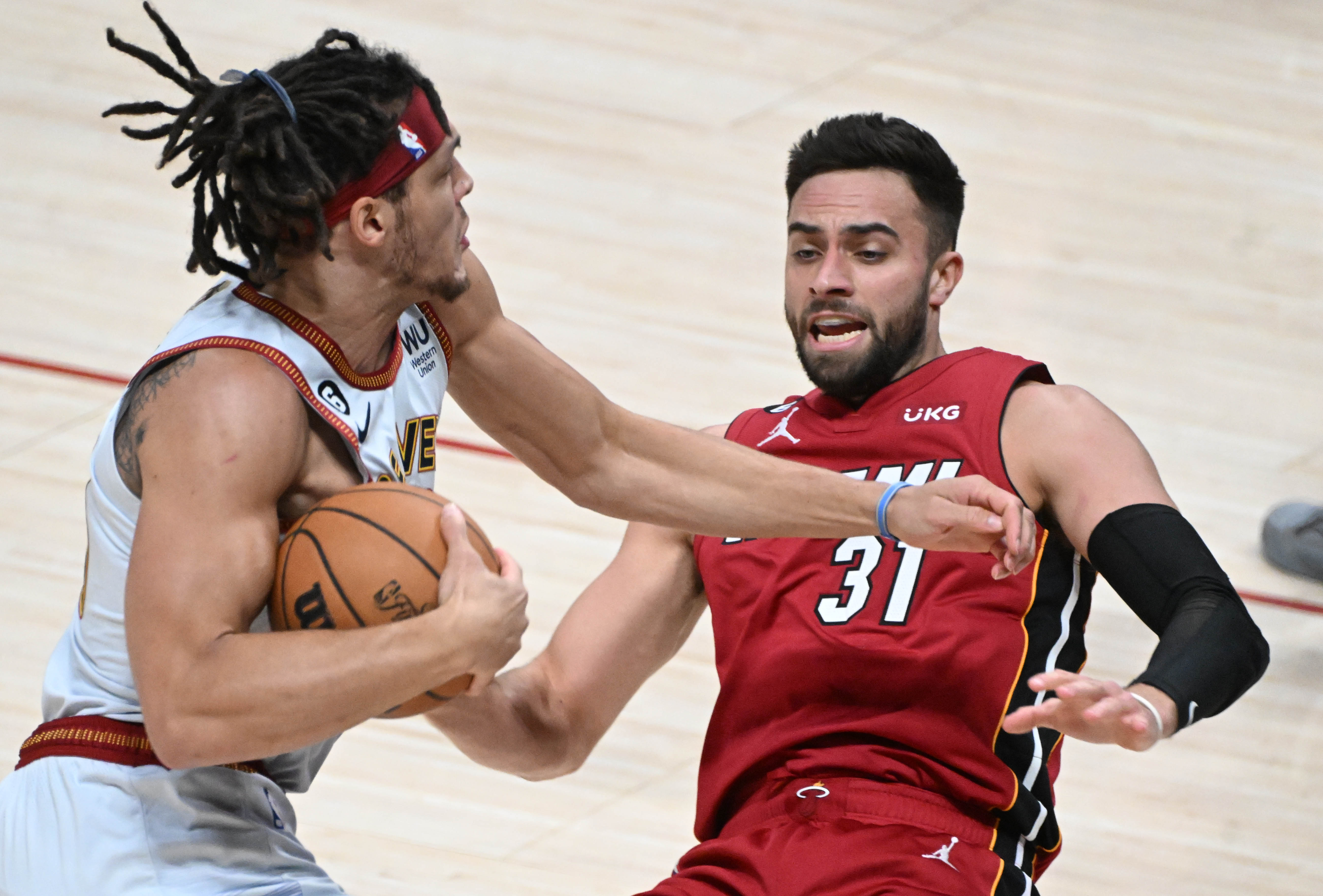 Denver Nuggets forward Aaron Gordon (50) collides Miami Heat guard Max Strus (31) during the first quarter of game 5 of the NBA Finals at Ball Arena on Monday, June 12, 2023. (Photo by Jerilee Bennett, The Gazette)