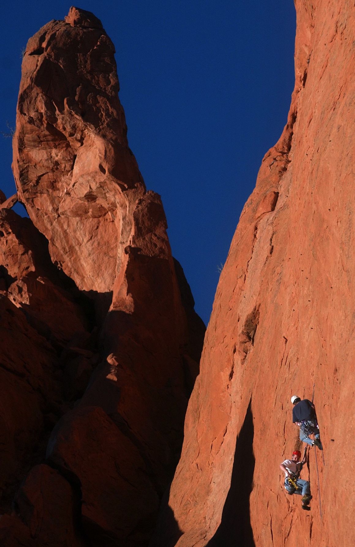 Rock climbers take advantage of a clear late afternoon on Thursday, Jan. 29, 2004 to scale the North Gateway Rock in the Garden of the Gods just below the Kissing Camels rock formation that sits above them. After a few days of below average temperatures the area finally heated up enough for visitors to stroll throught the park. Temperatures are expected to take a dip this weekend. The Gazette, Bryan Oller (Garden of the Gods. Bryan Oller)