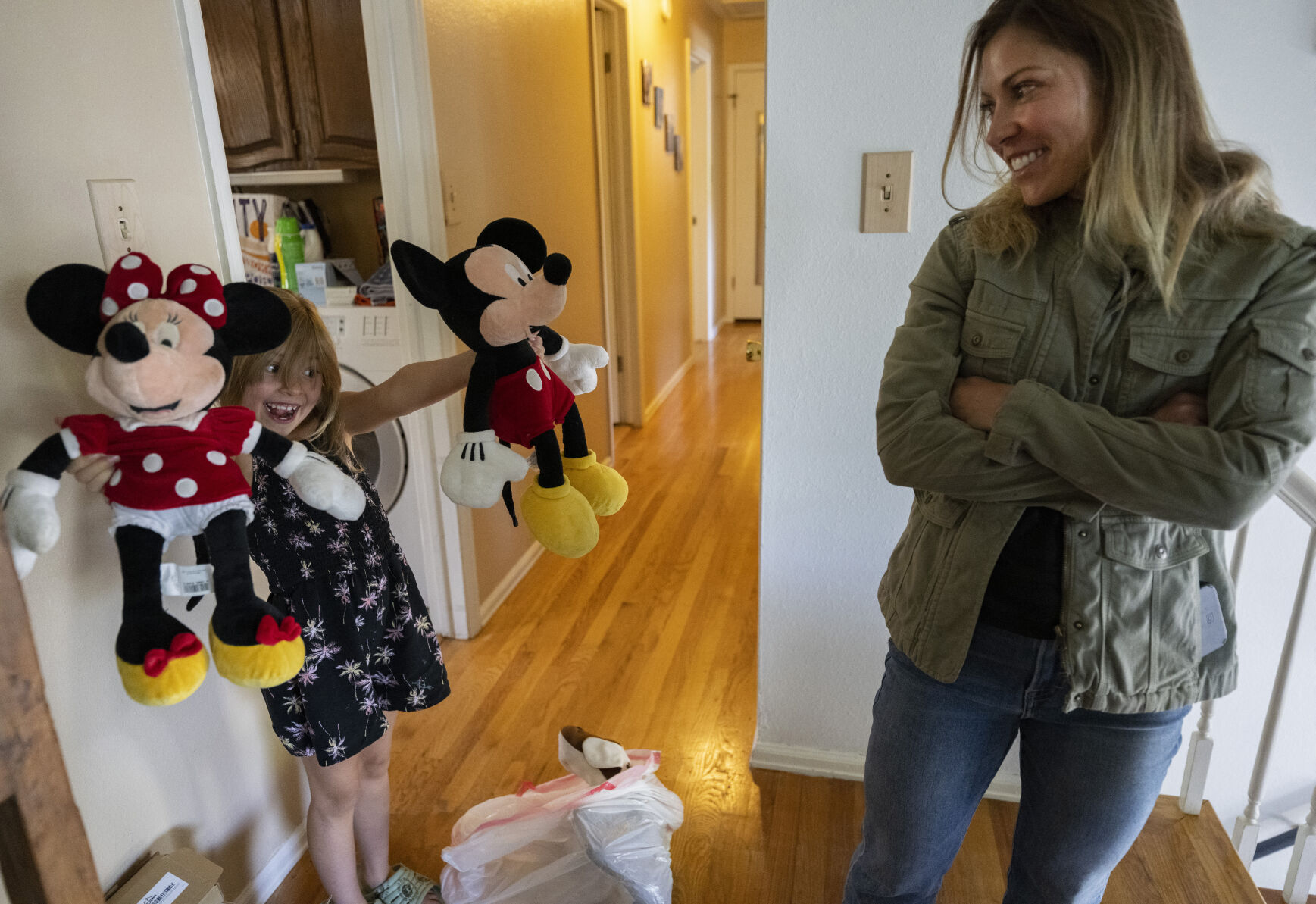 Dreama Walton’s daughter, Adelaide, 7, plays with Mickey and Minnie Mouse that were once owned by Dreama’s sister, Desiree, at their Colorado Springs home. Walton said she can’t get rid of some things such as the stuffed animals that gave her sister so much joy before she died at 19. (photos by Christian Murdock, The Gazette)
