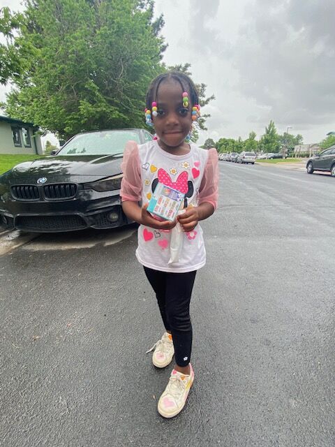 Sarah Kheri, 5, was happy to get a cop-sickle and a game at the Aztlan Recreation Center's summer kick-off, which happened Saturday, June 3. (Carol McKinley)