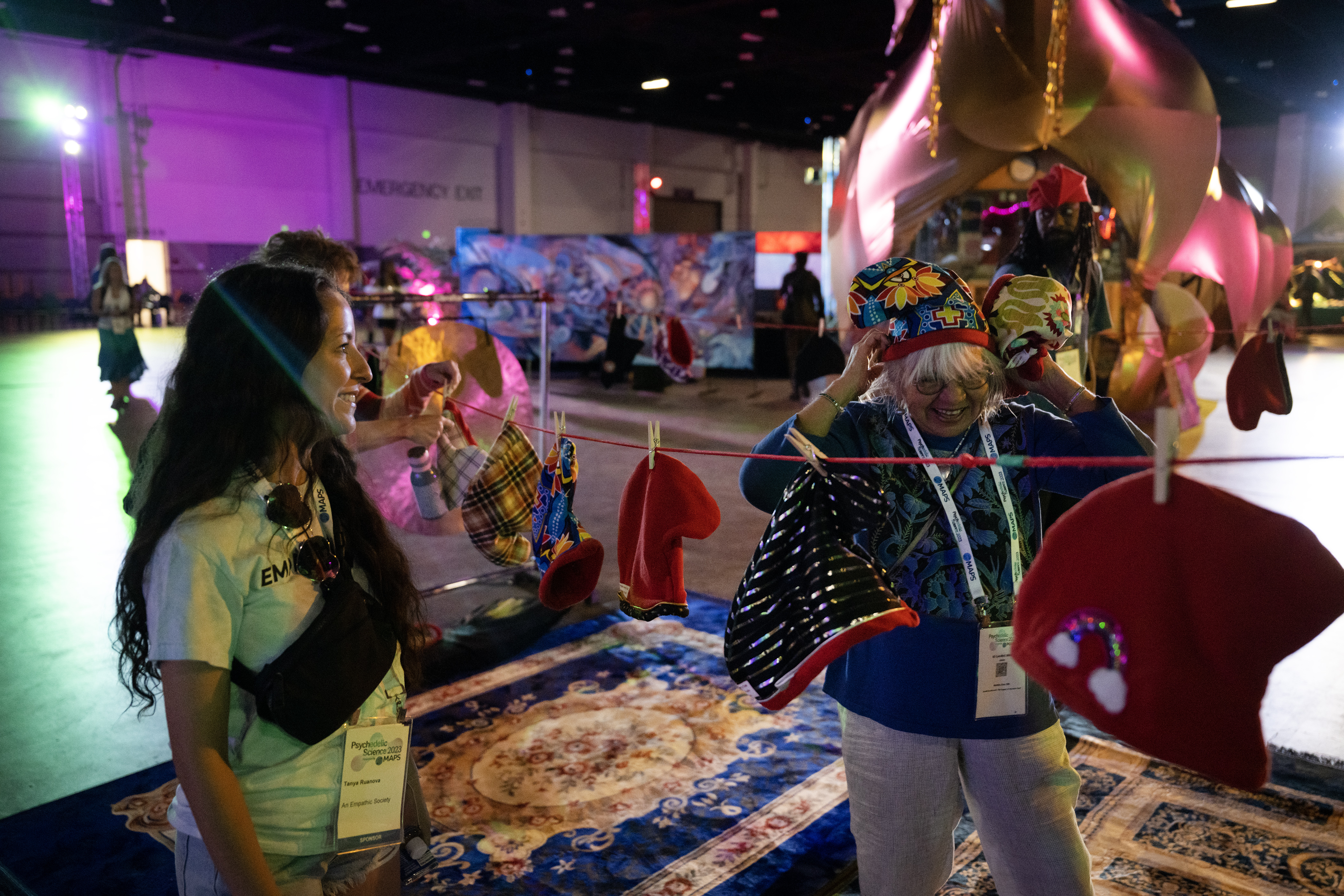 Tanya Ruanova, left, helps retired clinical nurse specialist in psychiatry Laura Io Berg pick out a Phrygian cap during the third day of Psychedelic Science 2023 on Wednesday, June 21, 2023, at the Colorado Convention Center in Denver. (Timothy Hurst/Denver Gazette) (TimHursttim.hurst@gazette.comhttps://secure.gravatar.com/avatar/aca82bd62b4ee425c598527cd6faa1b1?d=mm&r=g)