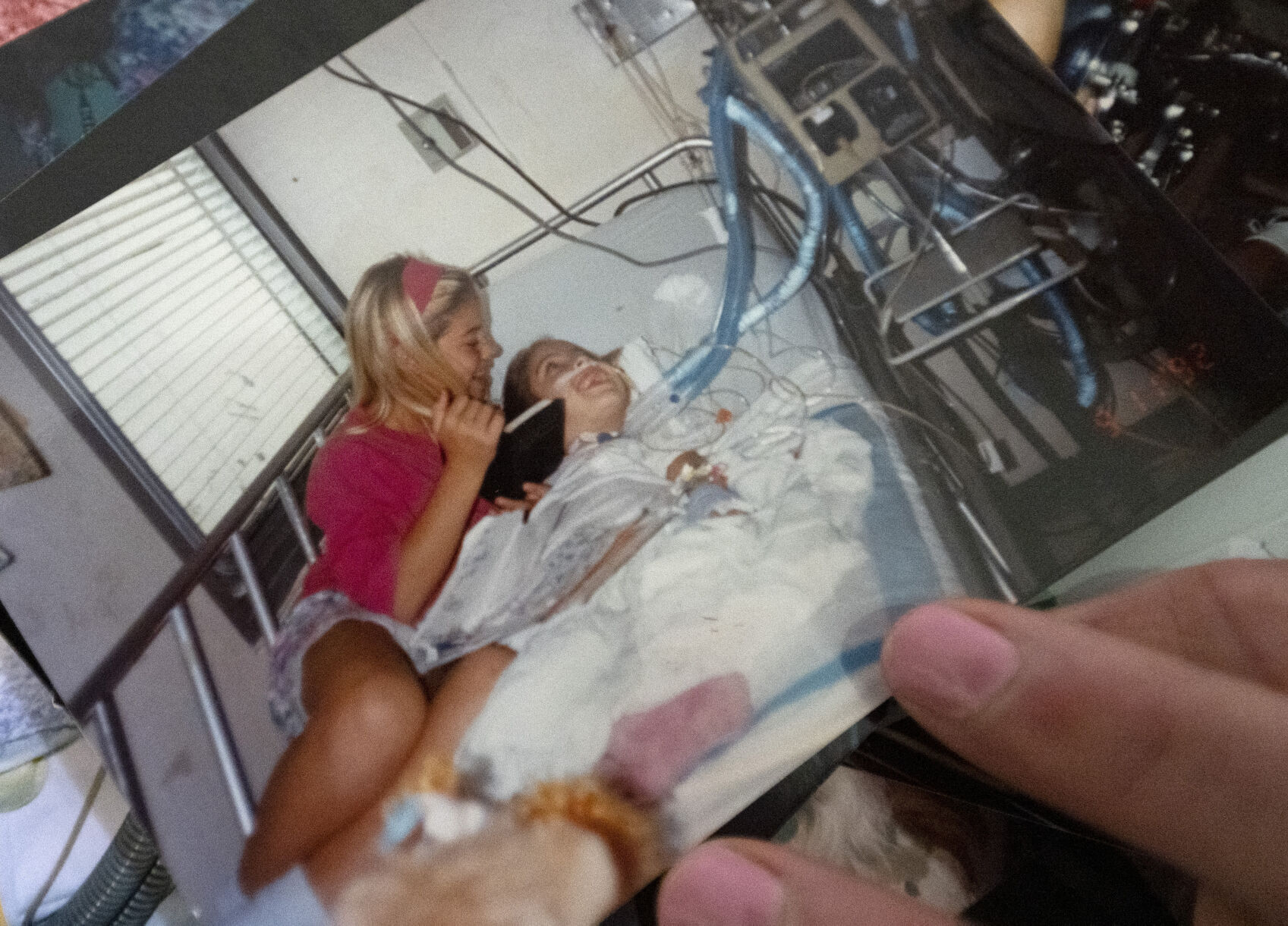 Dreama Walton, 11 at the time, cuddles with her sister, Desiree, who was 7, while she was in the hospital in San Juan, Puerto Rico in 1992. The family was living in St. Croix, in the U.S. Virgin Islands. (The Gazette, Christian Murdock) (Christian Murdock/The Gazette)